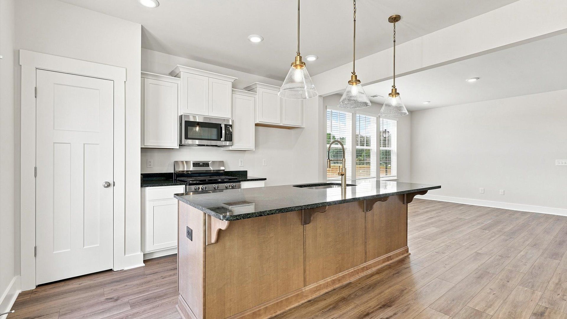 Memorable meals begin in this vibrant kitchen with pendant lighting and a thoughtfully designed island by DRB Homes