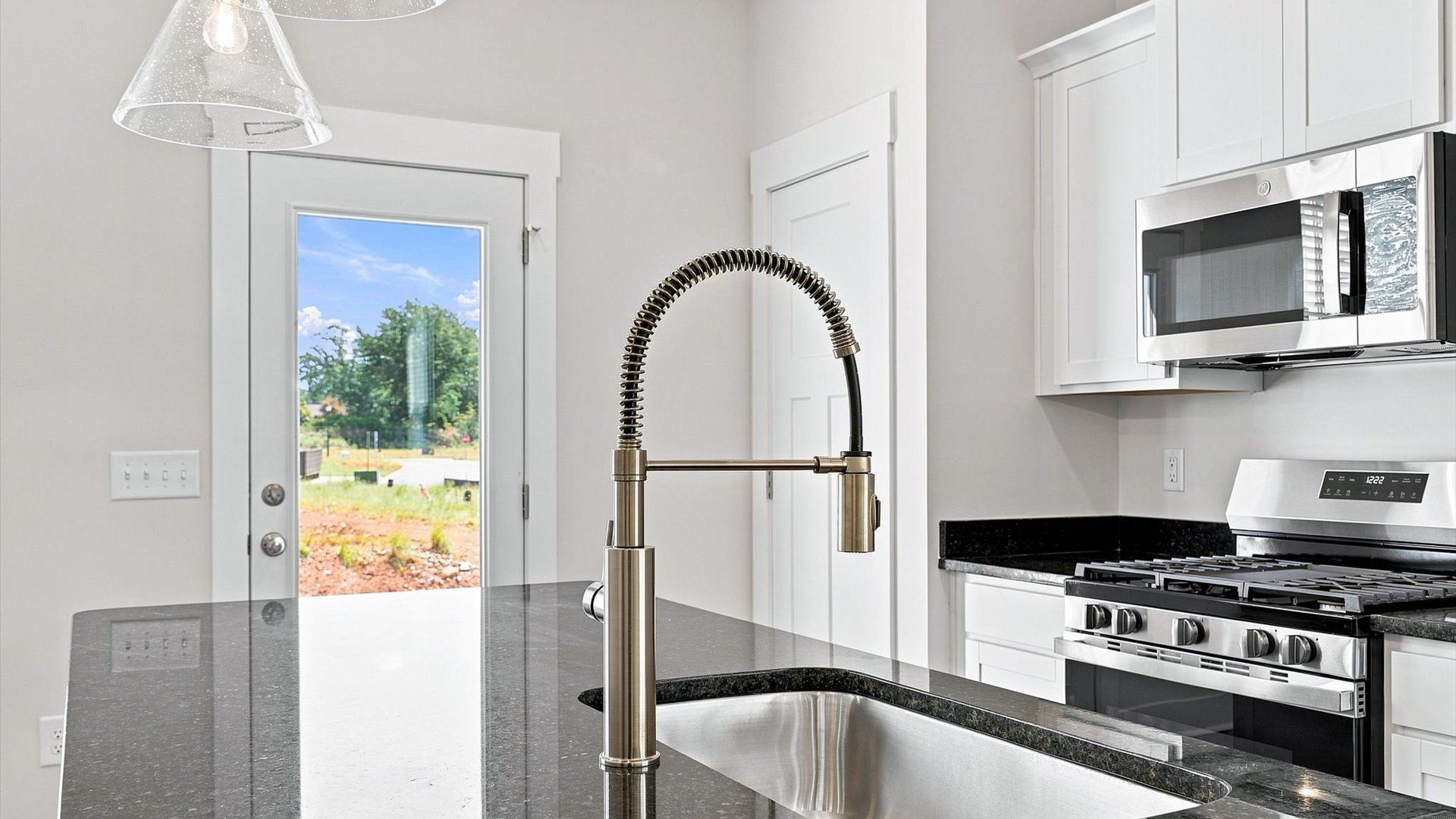 Elegant kitchen with large island and pendant lighting in this first-class DRB Homes design