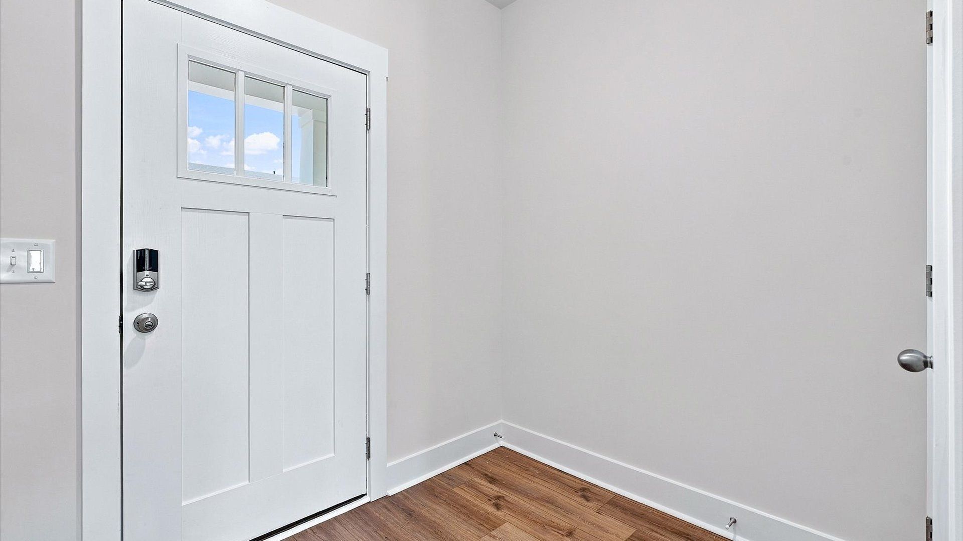 Memorable arrival experience with hardwood floors and elegant trim in the foyer located in Piedmont, SC