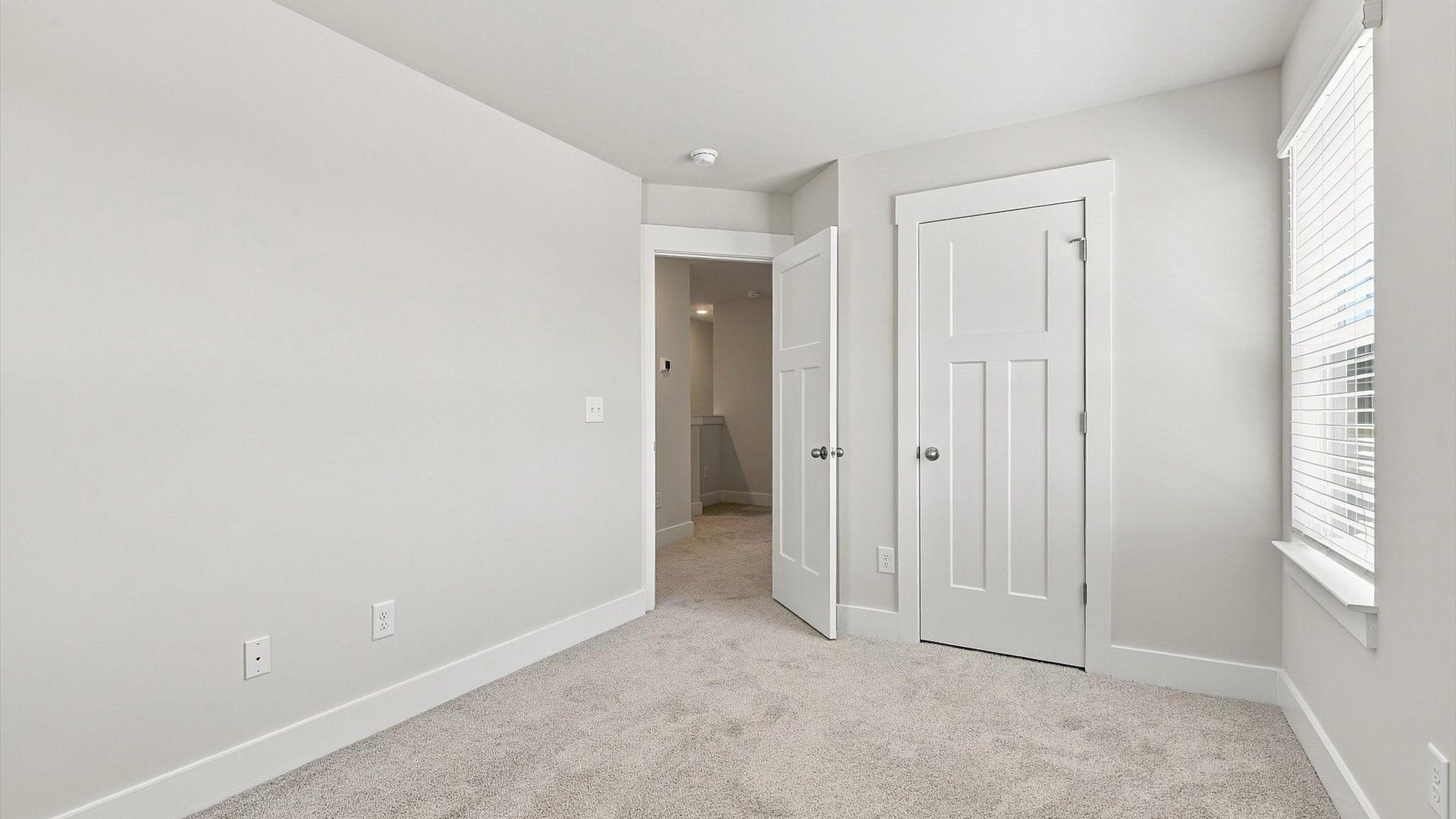 Accomplished design shines in this carpeted bedroom with a functional walk-in closet