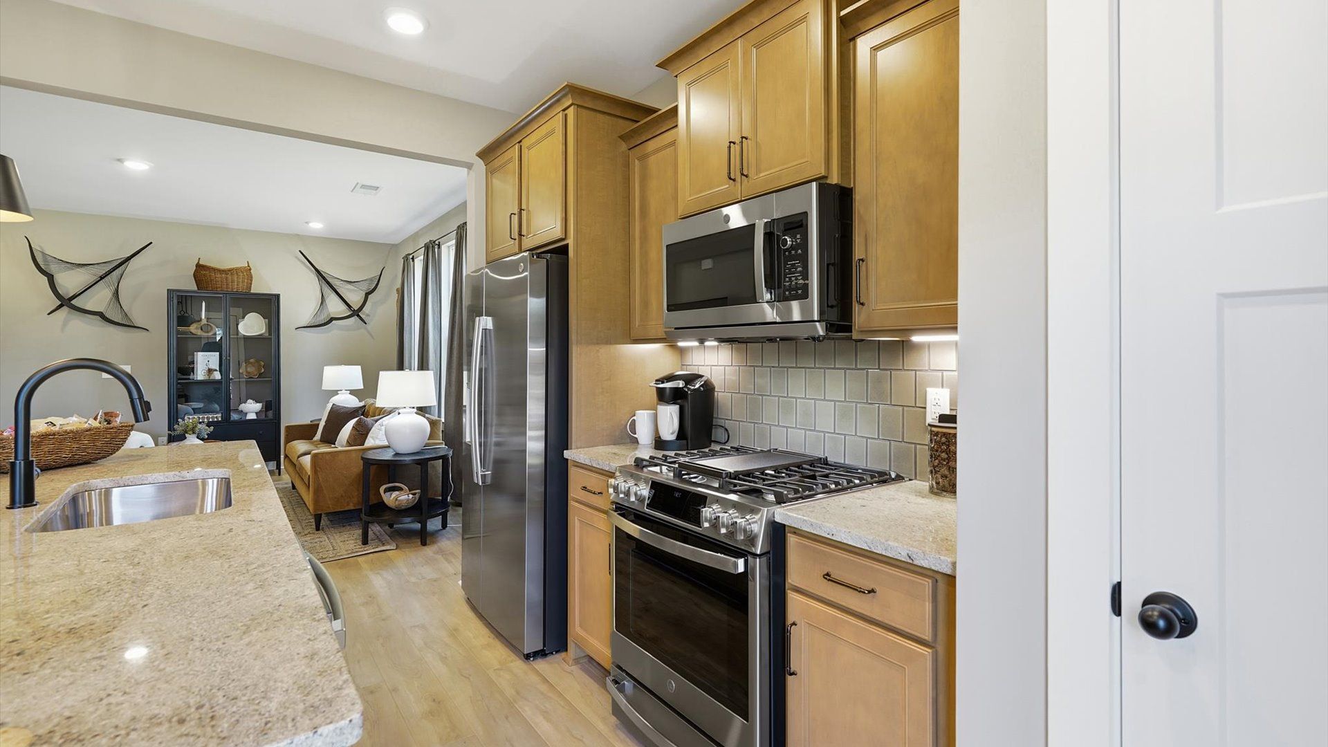 Tasteful kitchen with oversized island and stylish pendant lighting—crafted to high standards by DRB Homes