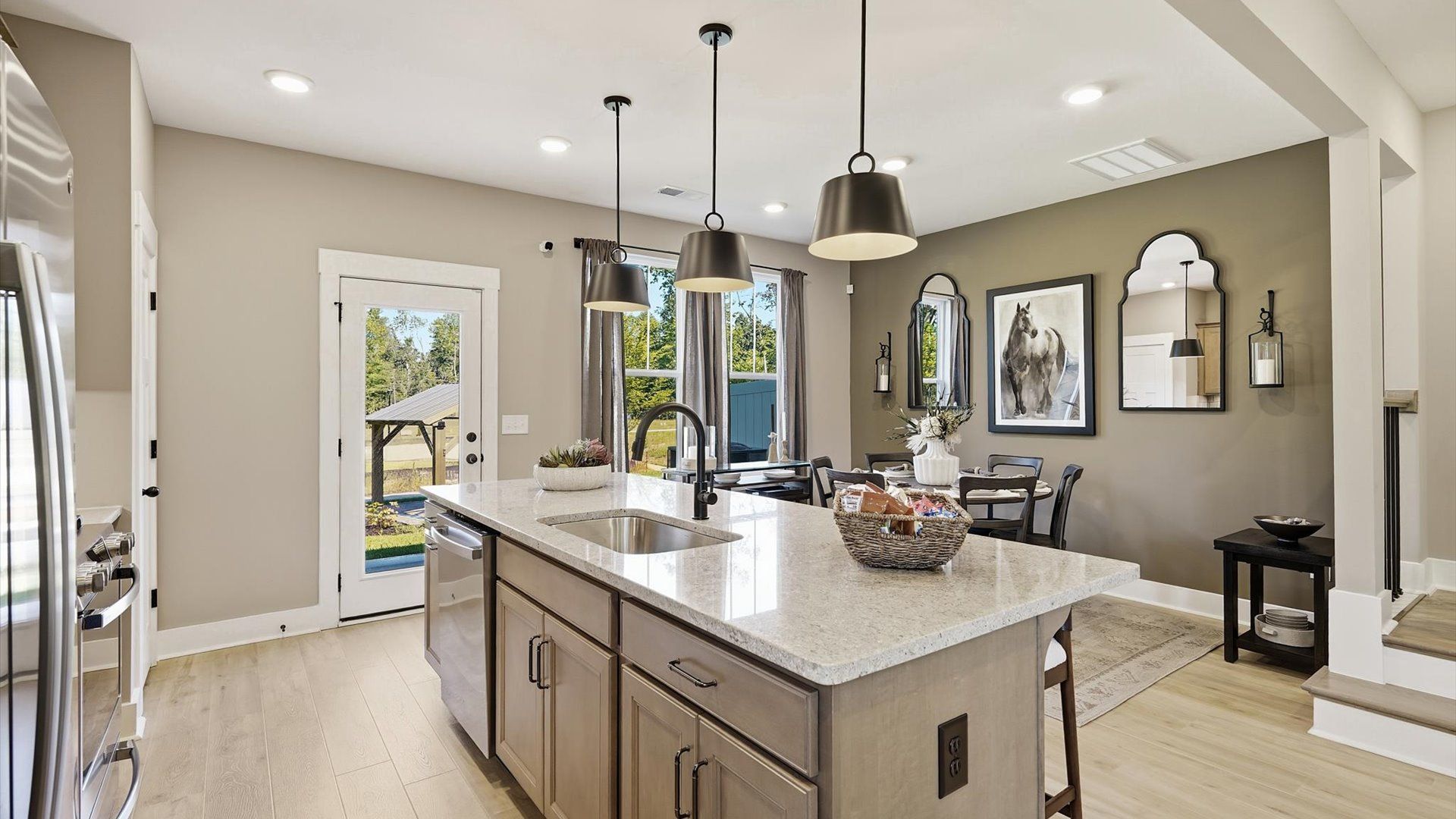 First-rate kitchen with functional layout, designer pendant lighting, and a large center island at Brookland Place