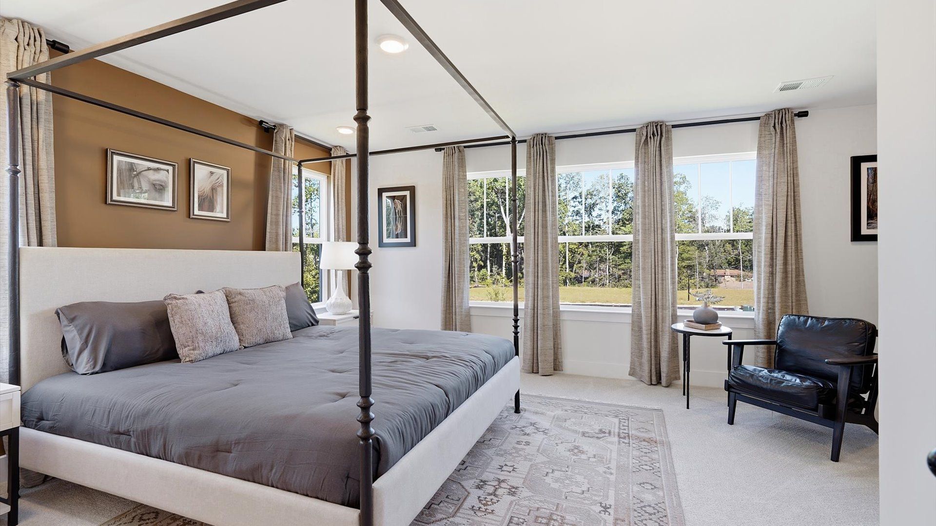 Serene and stylish primary bedroom featuring carpet flooring and a thoughtful, modern layout in Hendersonville, NC