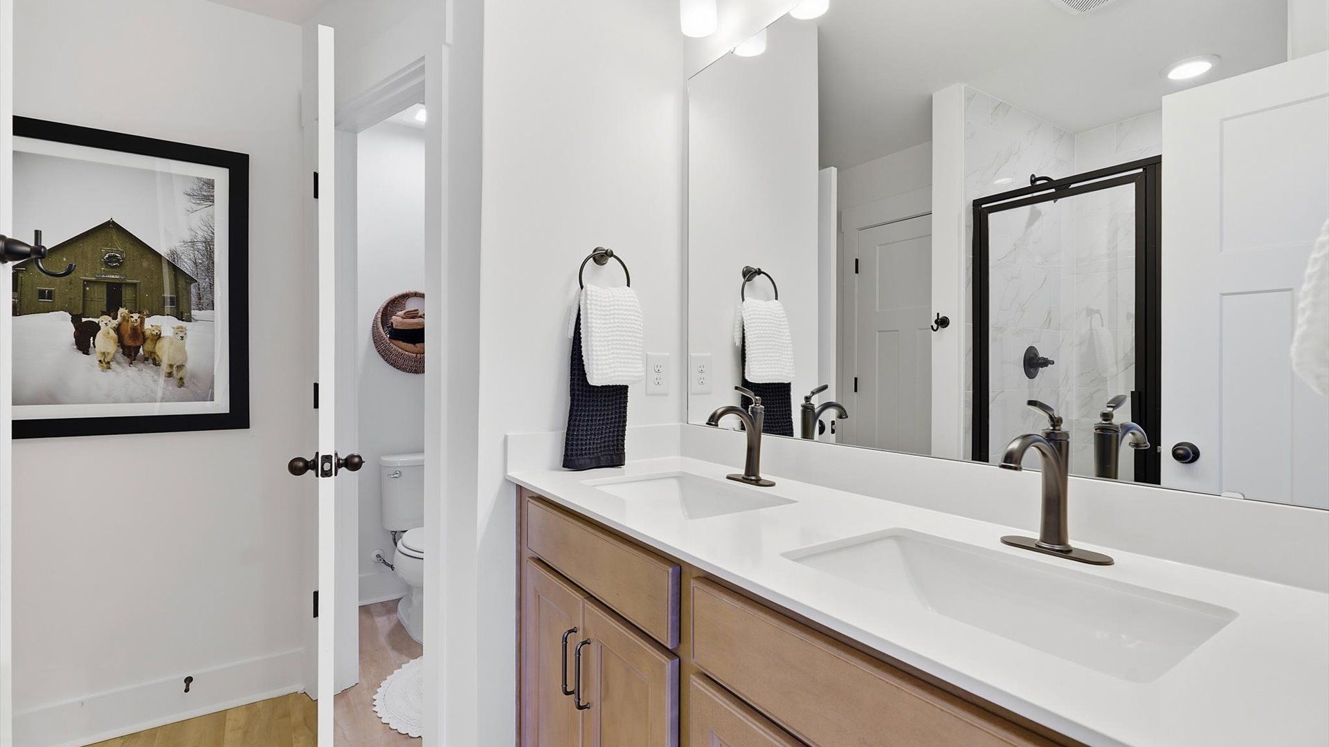 Notable primary suite with dual vanities and walk-in shower in this prime Hendersonville villa