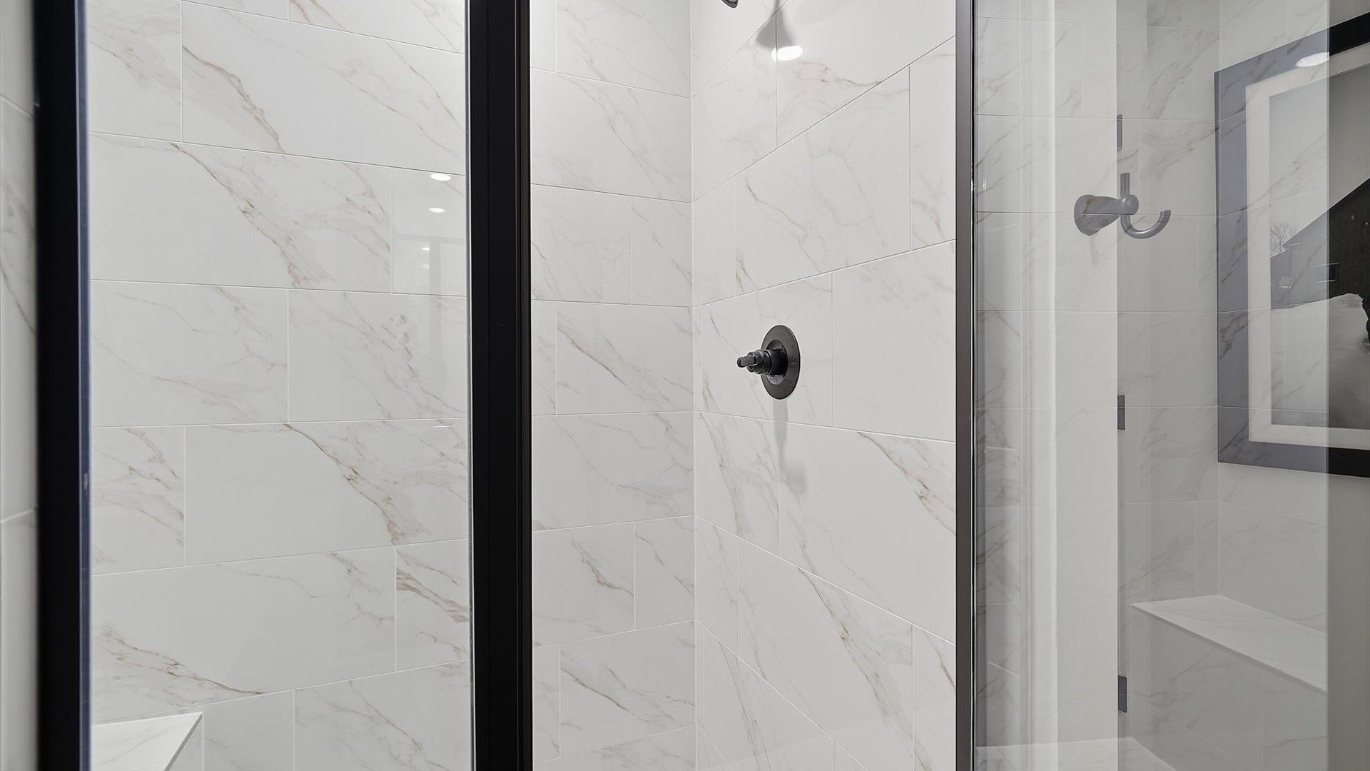 Sophisticated primary bathroom with expansive walk-in shower and polished hardware by DRB Homes