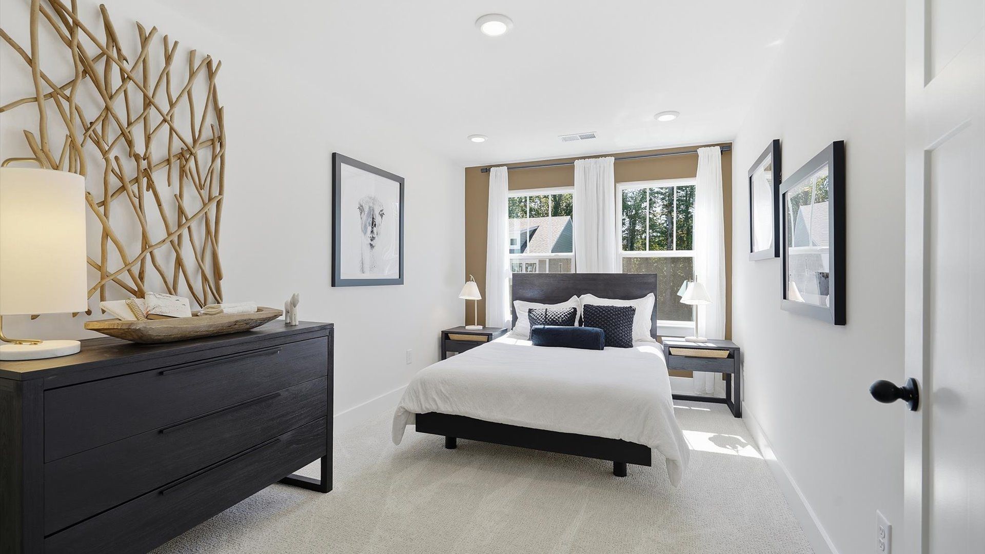 Highly functional bedroom with large windows, carpeted flooring, and tasteful finishes throughout by DRB Homes