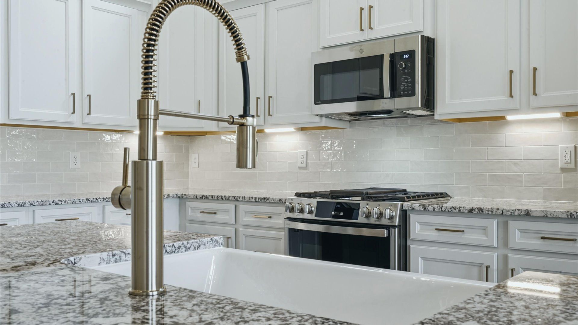 Superior craftsmanship shines in this modern kitchen with granite countertops and open flow