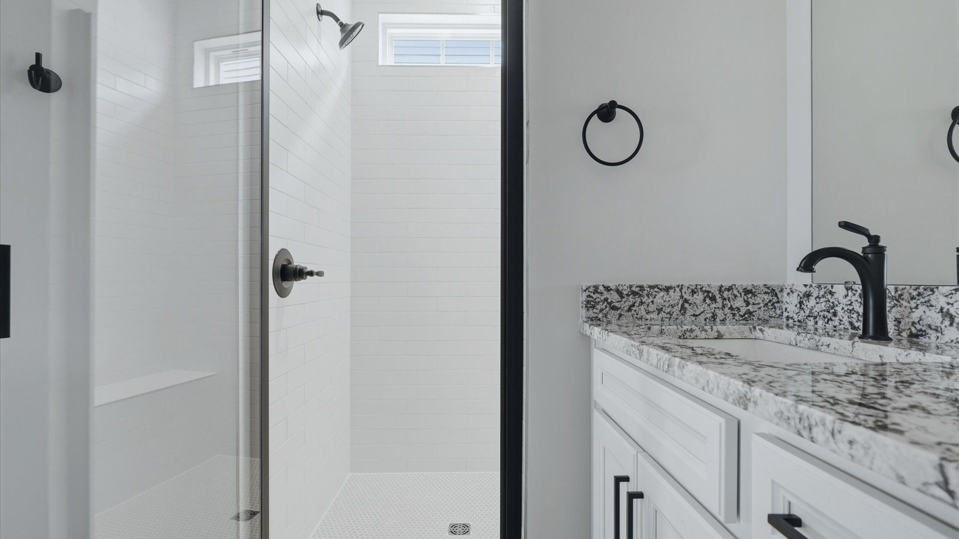 Accomplished design shines in this primary bath with dual vanity and a sleek walk-in shower at Fox Hollow