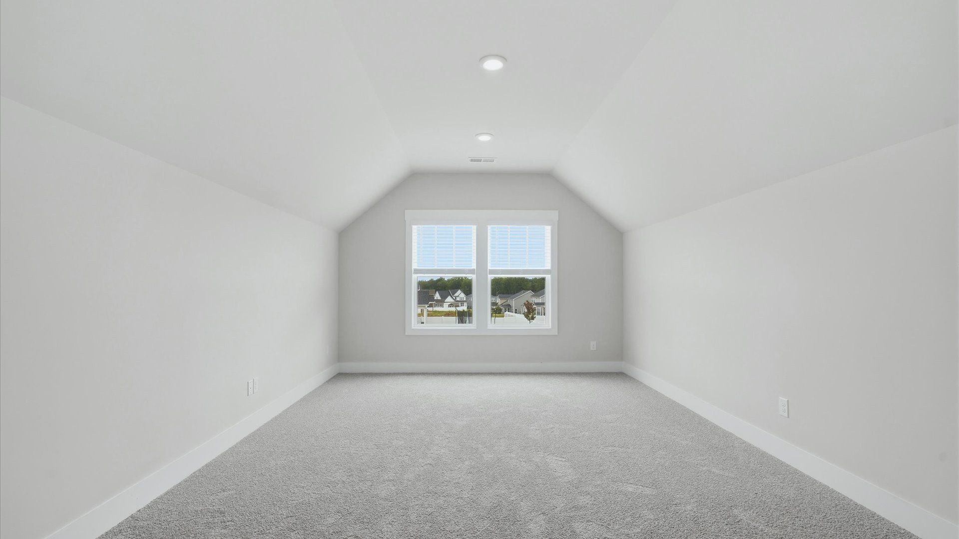 Functional bonus room with tasteful carpet floors and exceptional natural light in a modern home