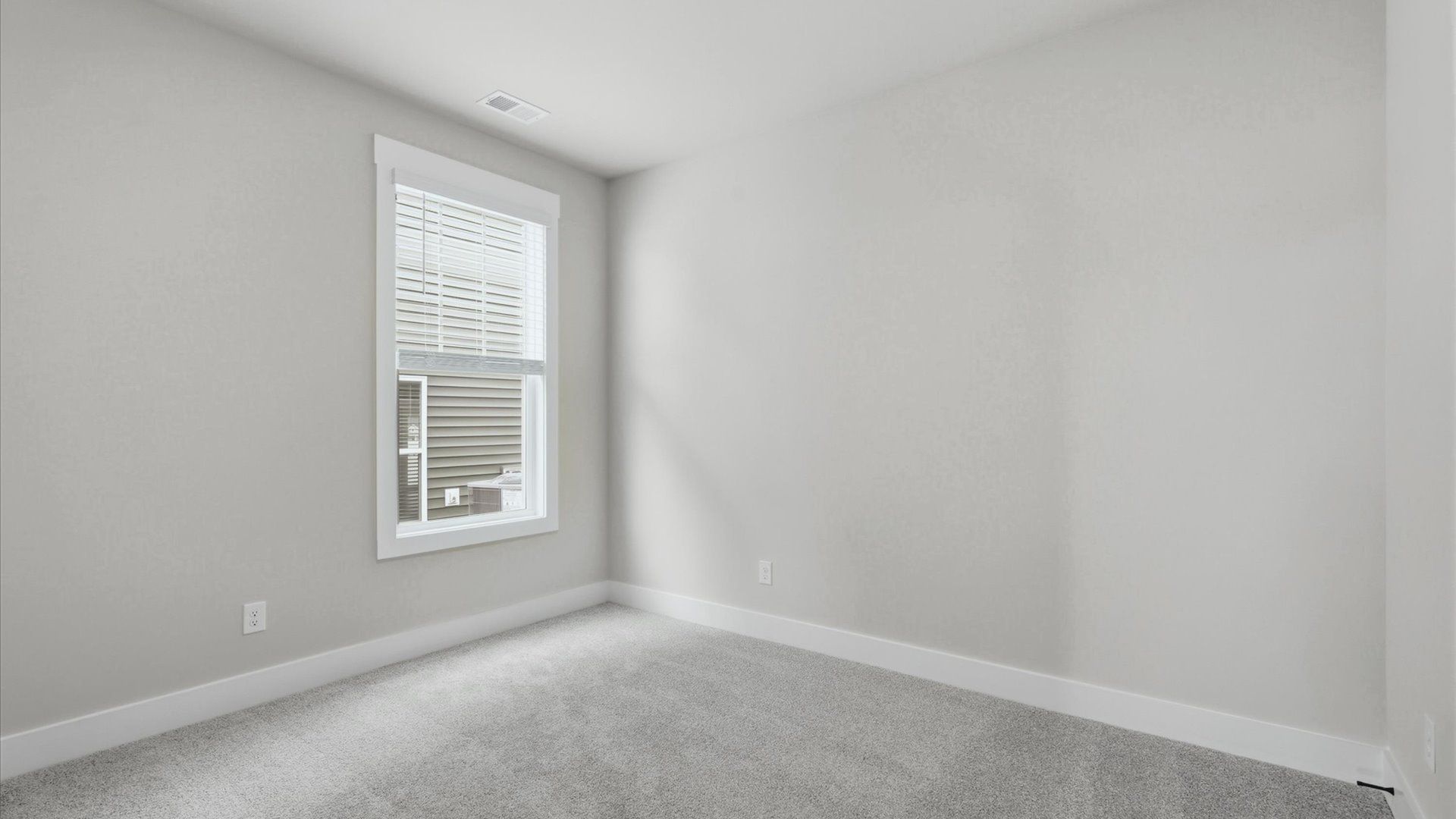 Refined bedroom design with large windows for daylight-filled mornings and peaceful views