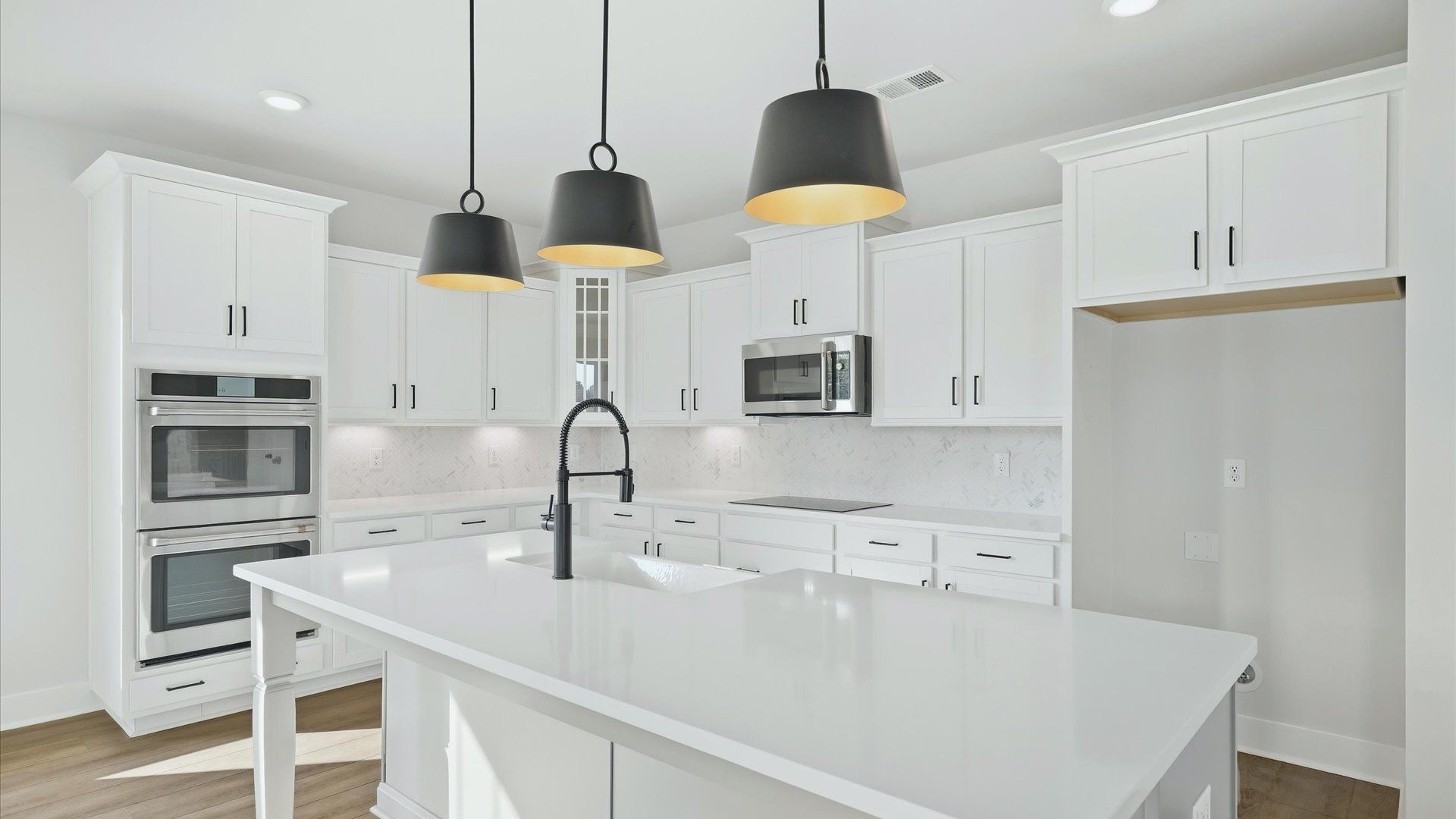 Exclusive kitchen design with large island, pendant lights, and tasteful finishes throughout in Woodruff, SC