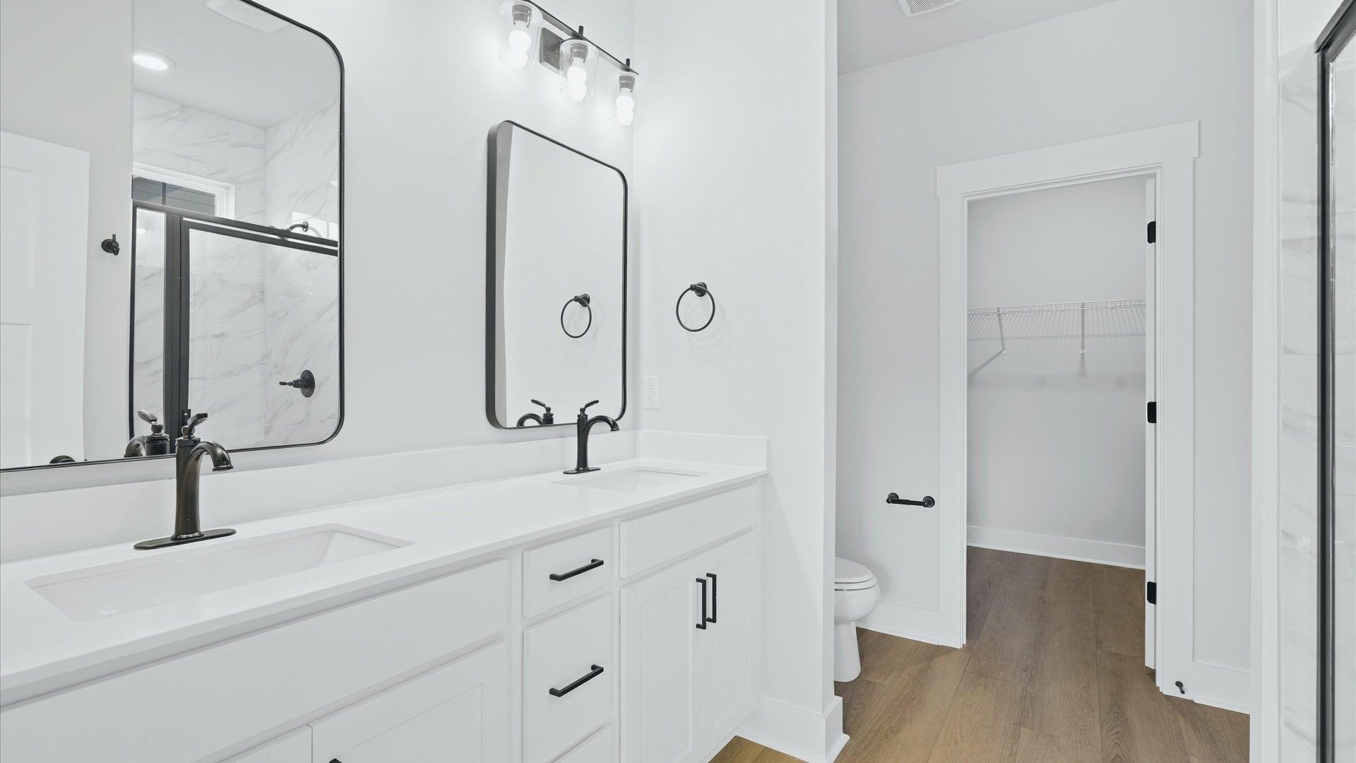Spacious and modern primary bathroom with walk-in shower and first-class double vanity setup at Pinebrook