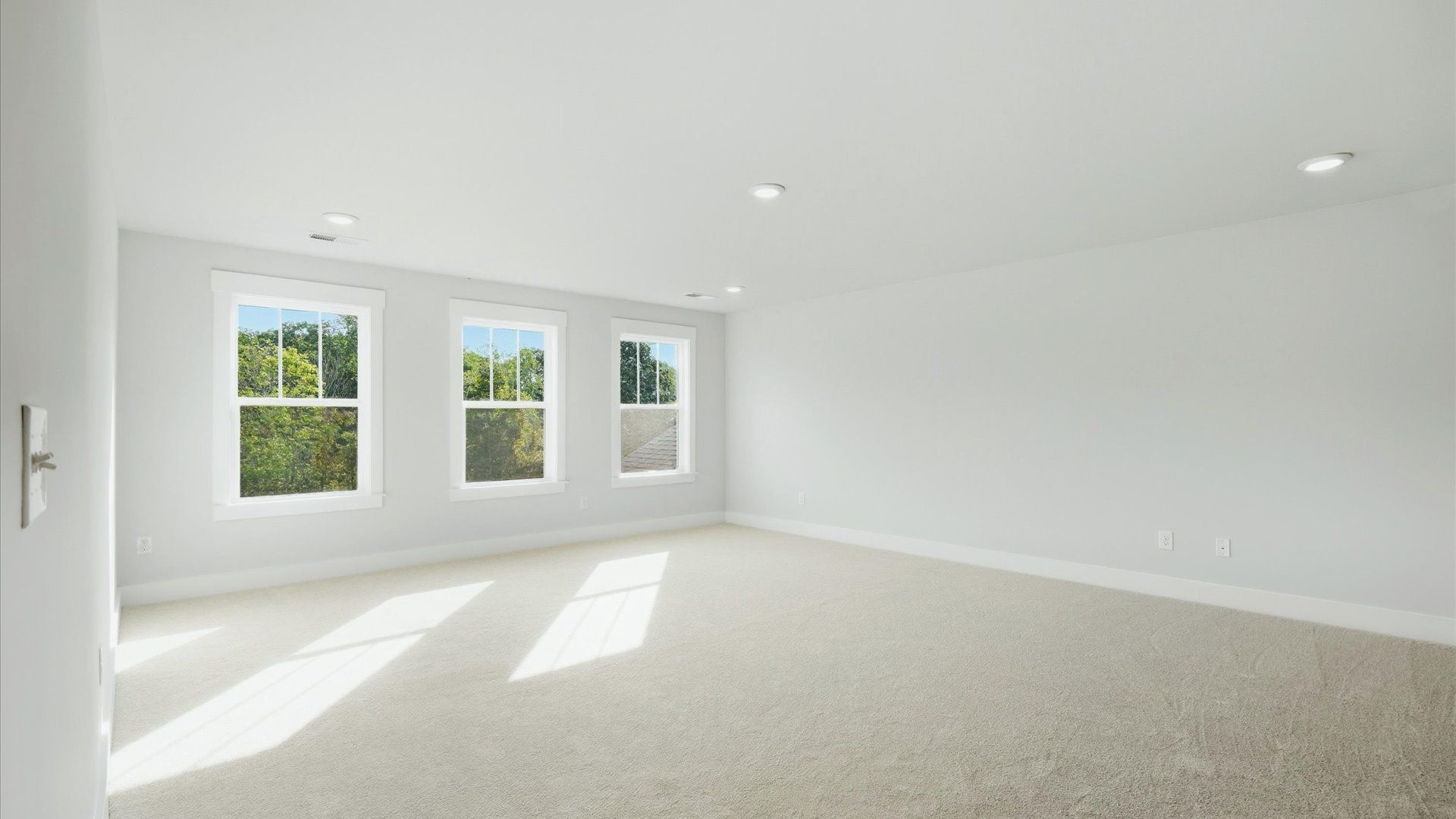 Refined bedroom design with large windows for daylight-filled mornings and peaceful views