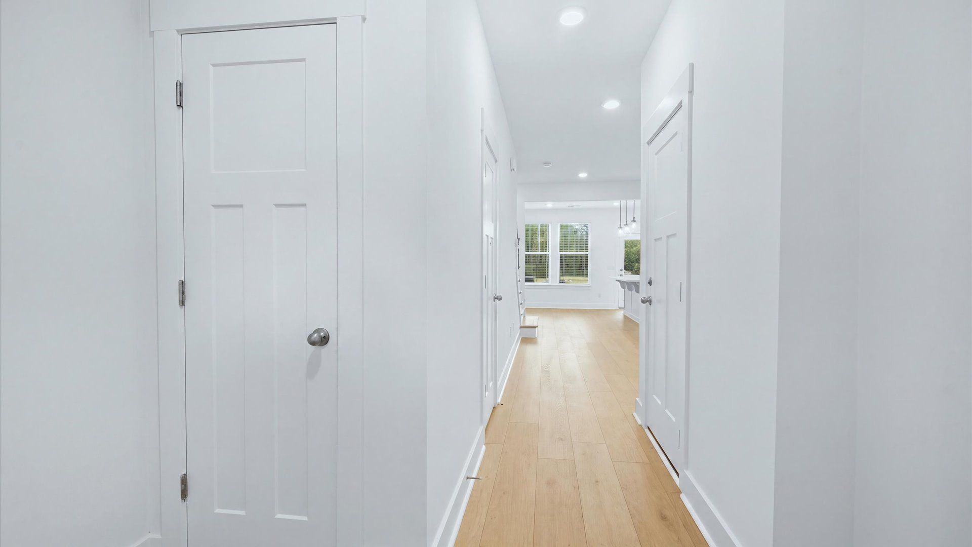 Notable hardwood flooring enhances the elegance of this accomplished entryway by DRB Homes