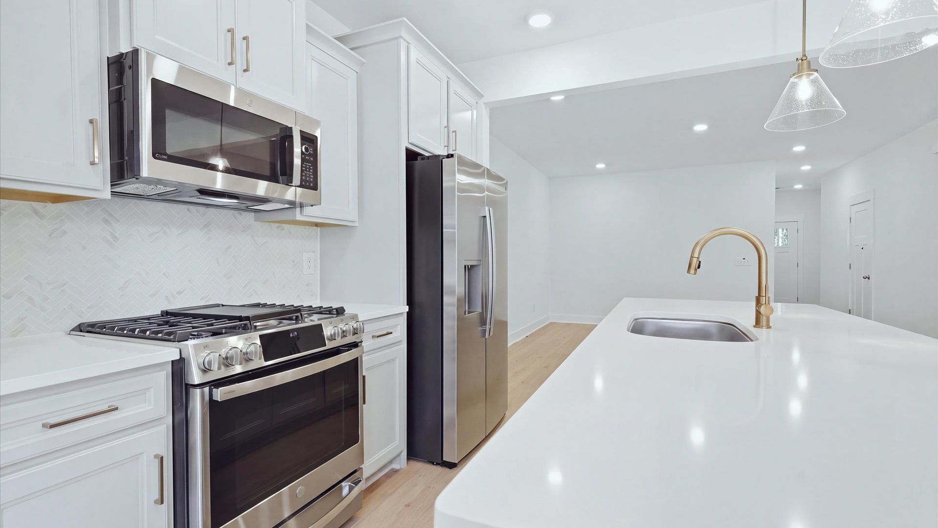 Bright and airy culinary space with generous prep areas and contemporary lighting by DRB Homes