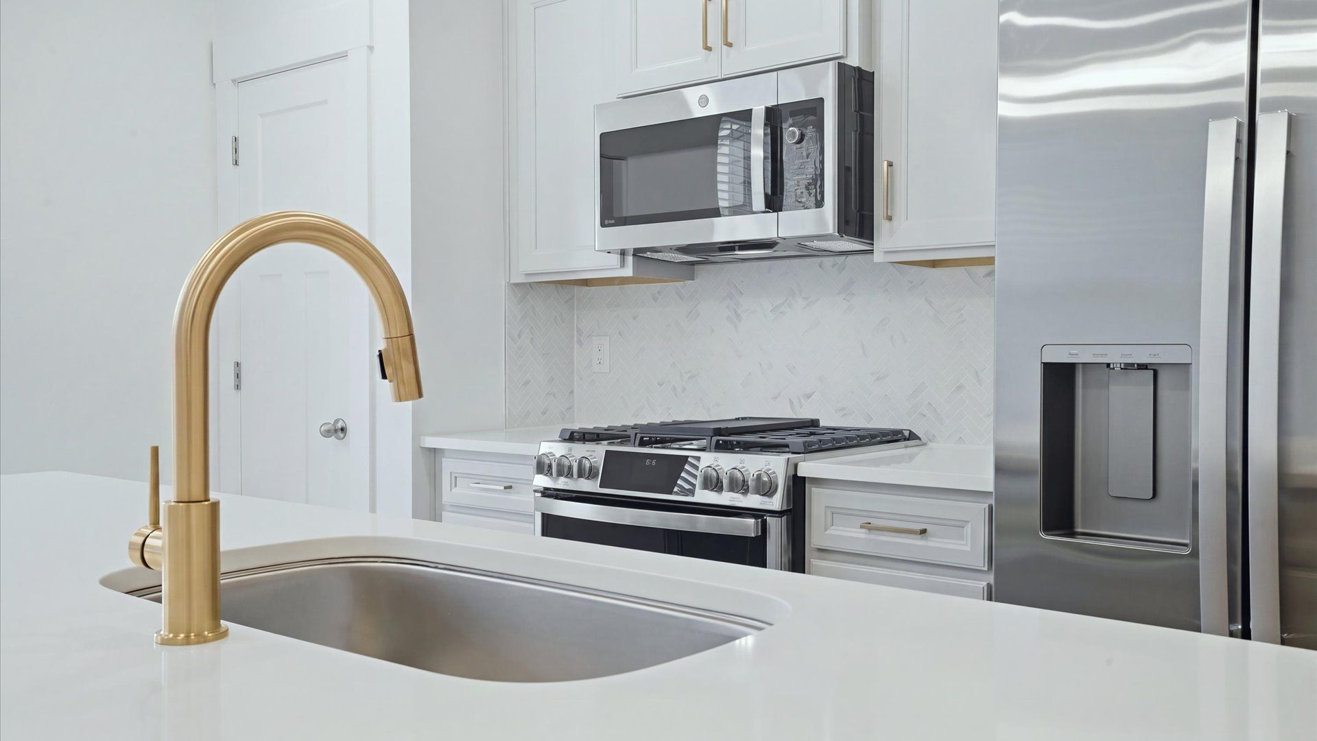 Accomplished design in a kitchen that blends function and form with a right-sized island by DRB Homes