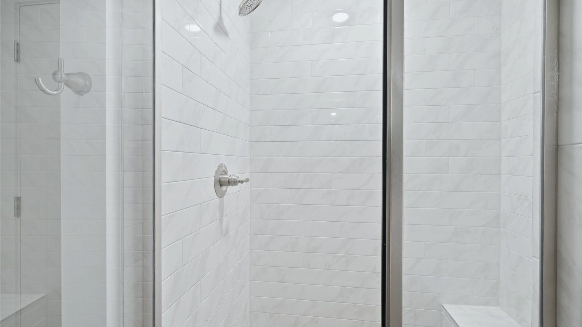 Superior en-suite primary bathroom with stylish walk-in shower—crafted with high standards in mind