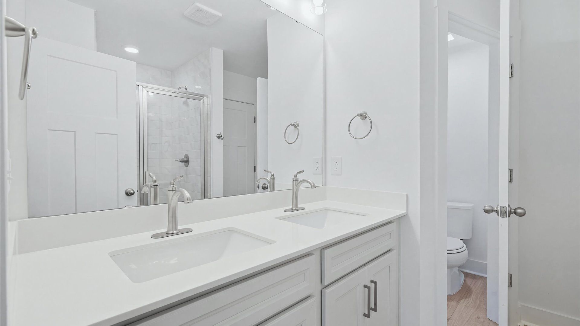 Memorable mornings begin in this elegant primary bathroom with walk-in shower and double vanity near the Blue Ridge Parkway