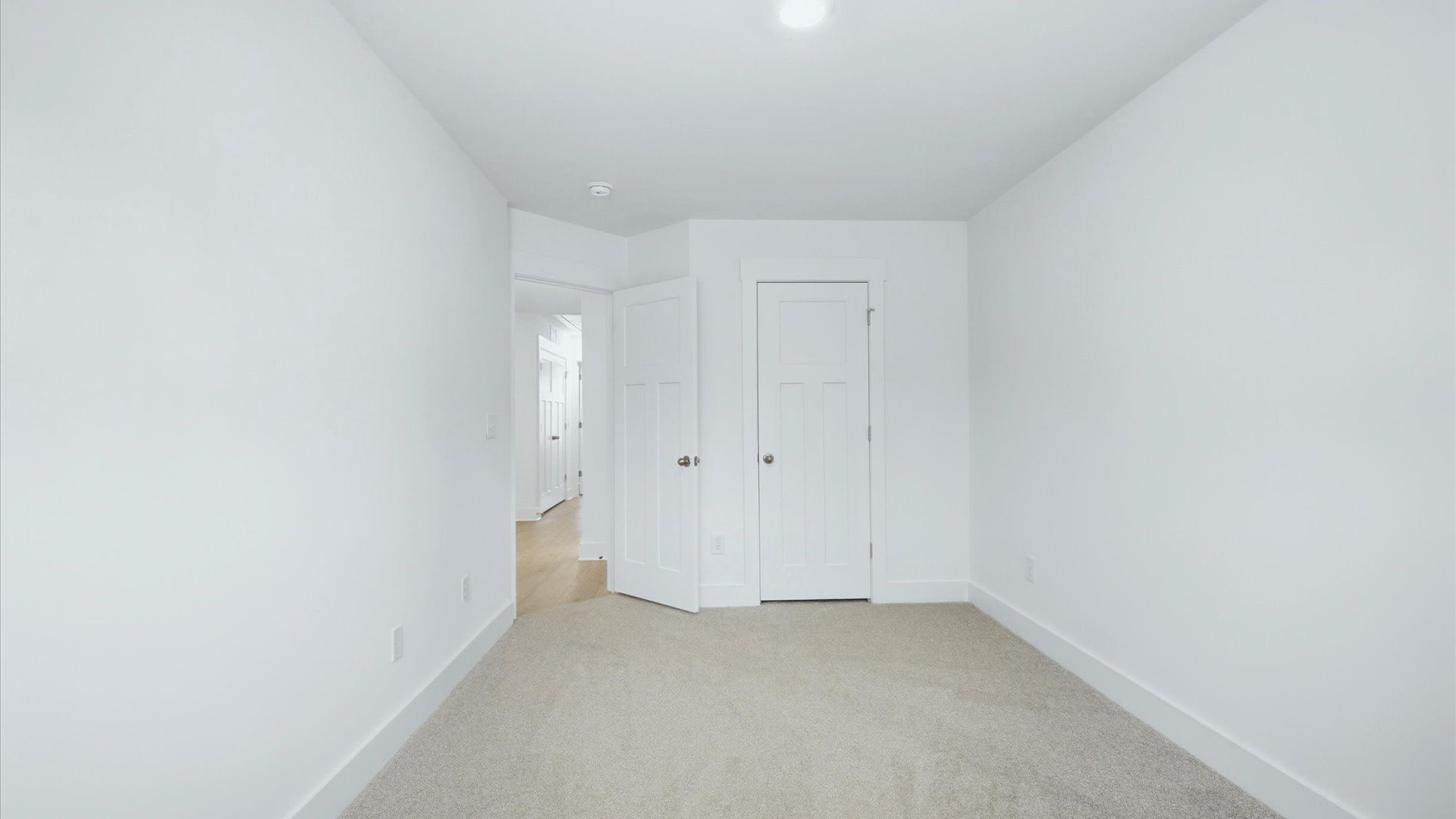 Superior comfort in a secondary bedroom with plush carpet and a spacious walk-in closet by DRB Homes