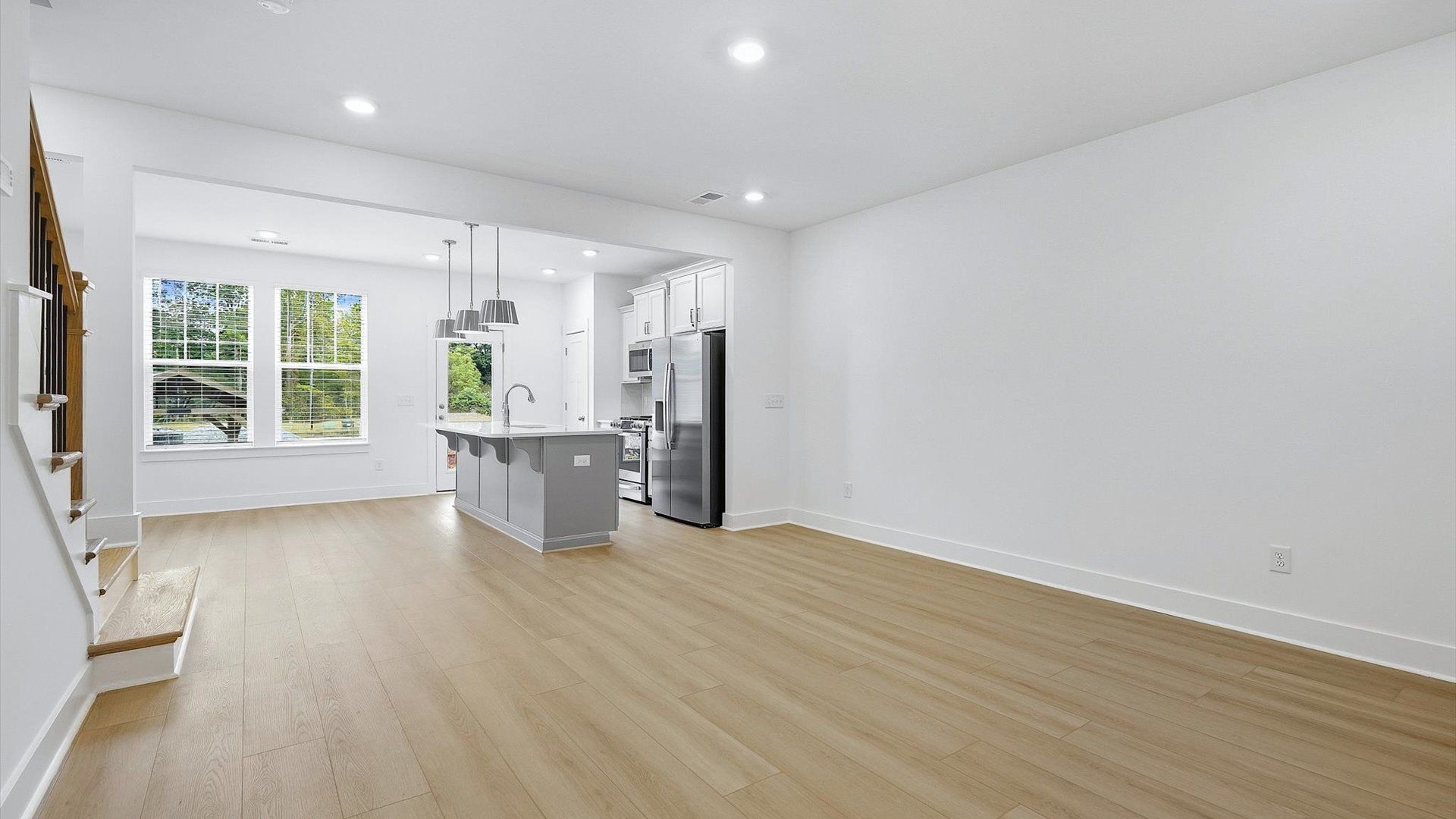 Spacious family room with rich hardwood flooring and elegant trim work in a reputable DRB Homes build