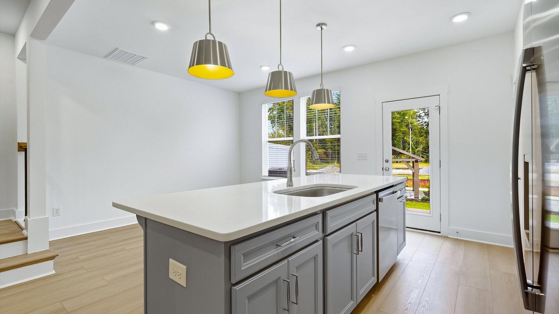 Well-designed kitchen with a center island and tasteful finishes that elevate everyday living by DRB Homes