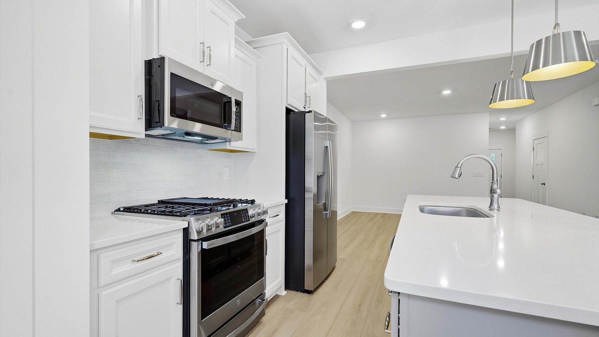 Exceptional kitchen featuring a spacious island, eye-catching pendant lights, and modern finishes in Hendersonville, NC