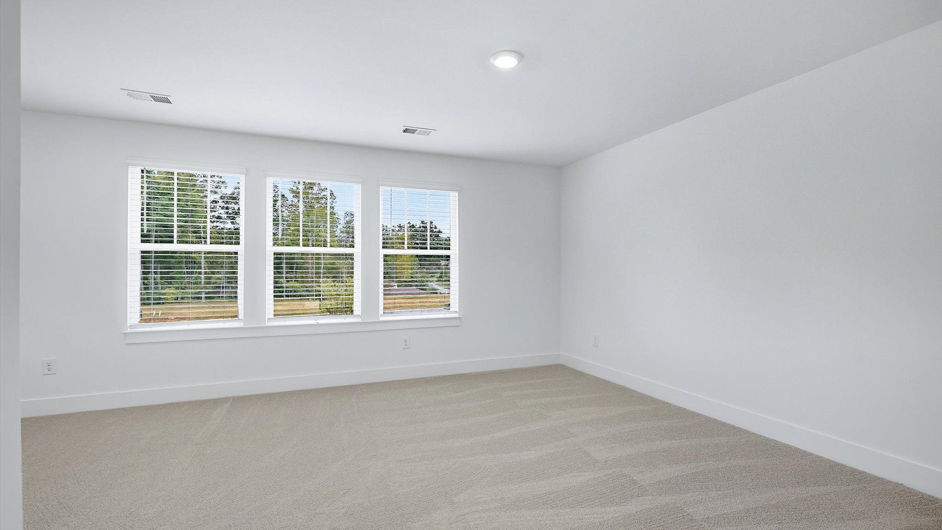 Elegant primary suite with tray ceiling and walk-in closet in this top-notch Brookland Place villa
