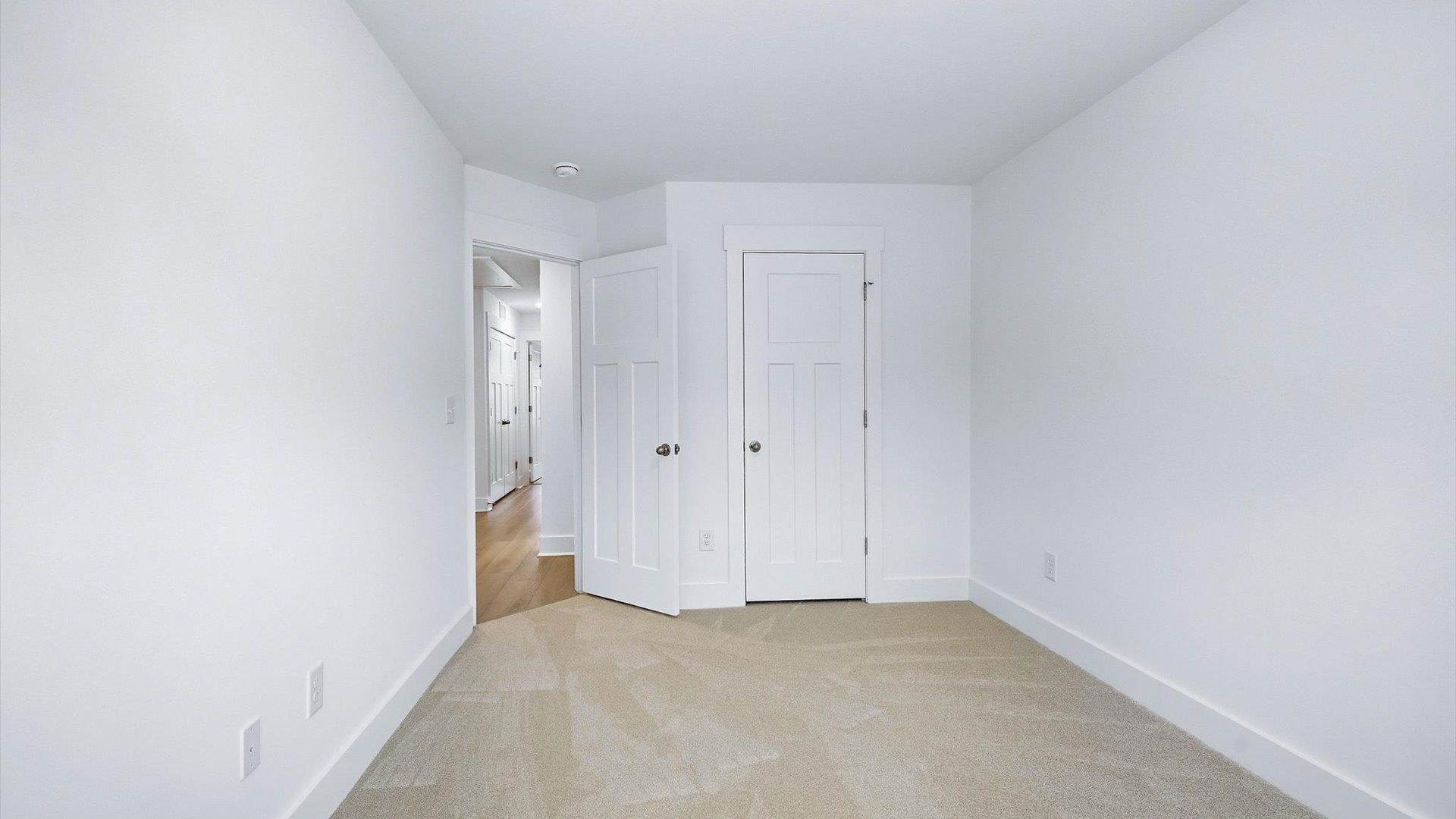 First-class secondary bedroom with comfortable carpeted flooring and generous closet space by DRB Homes