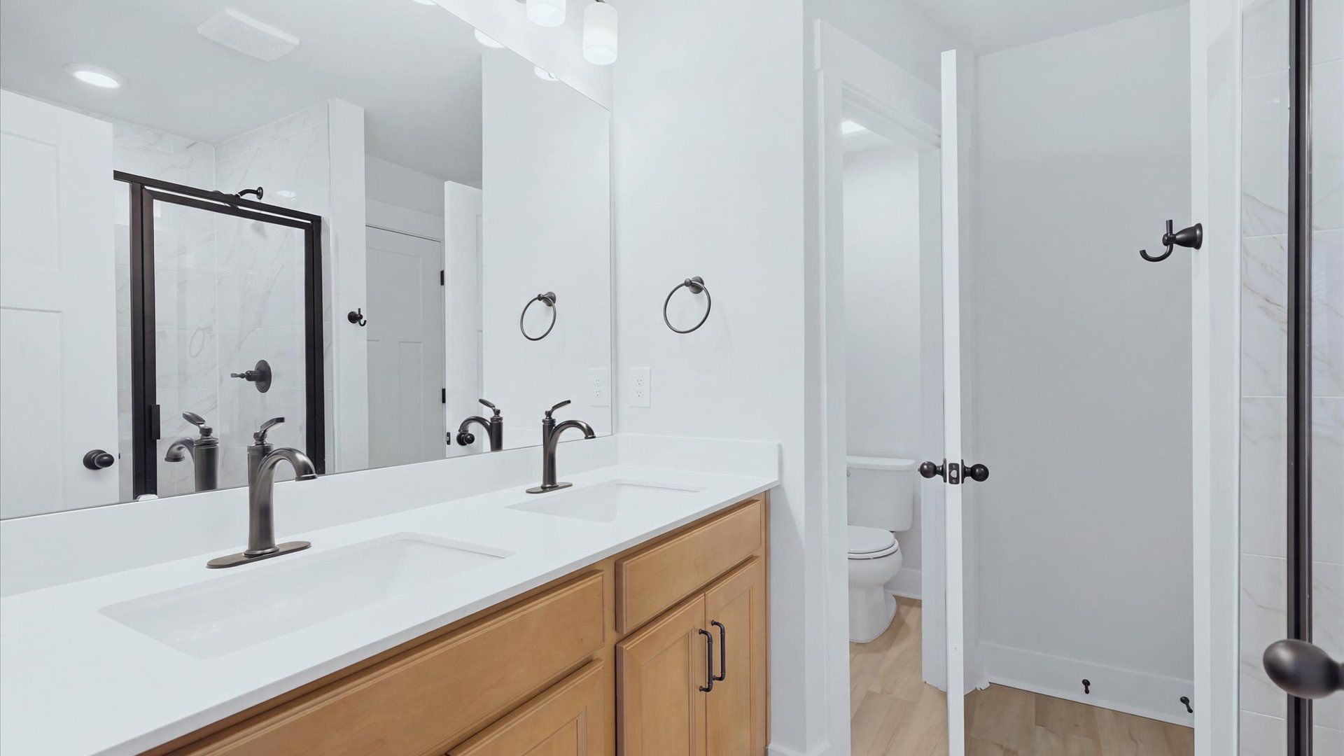 Exceptional en-suite with dual vanity and glass-enclosed walk-in shower for superior everyday comfort