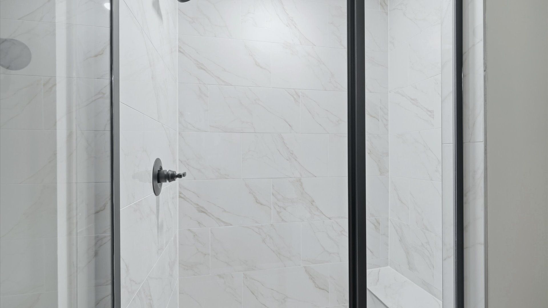 Memorable mornings begin in this elegant primary bathroom with walk-in shower and double vanity in Hendersonville, NC