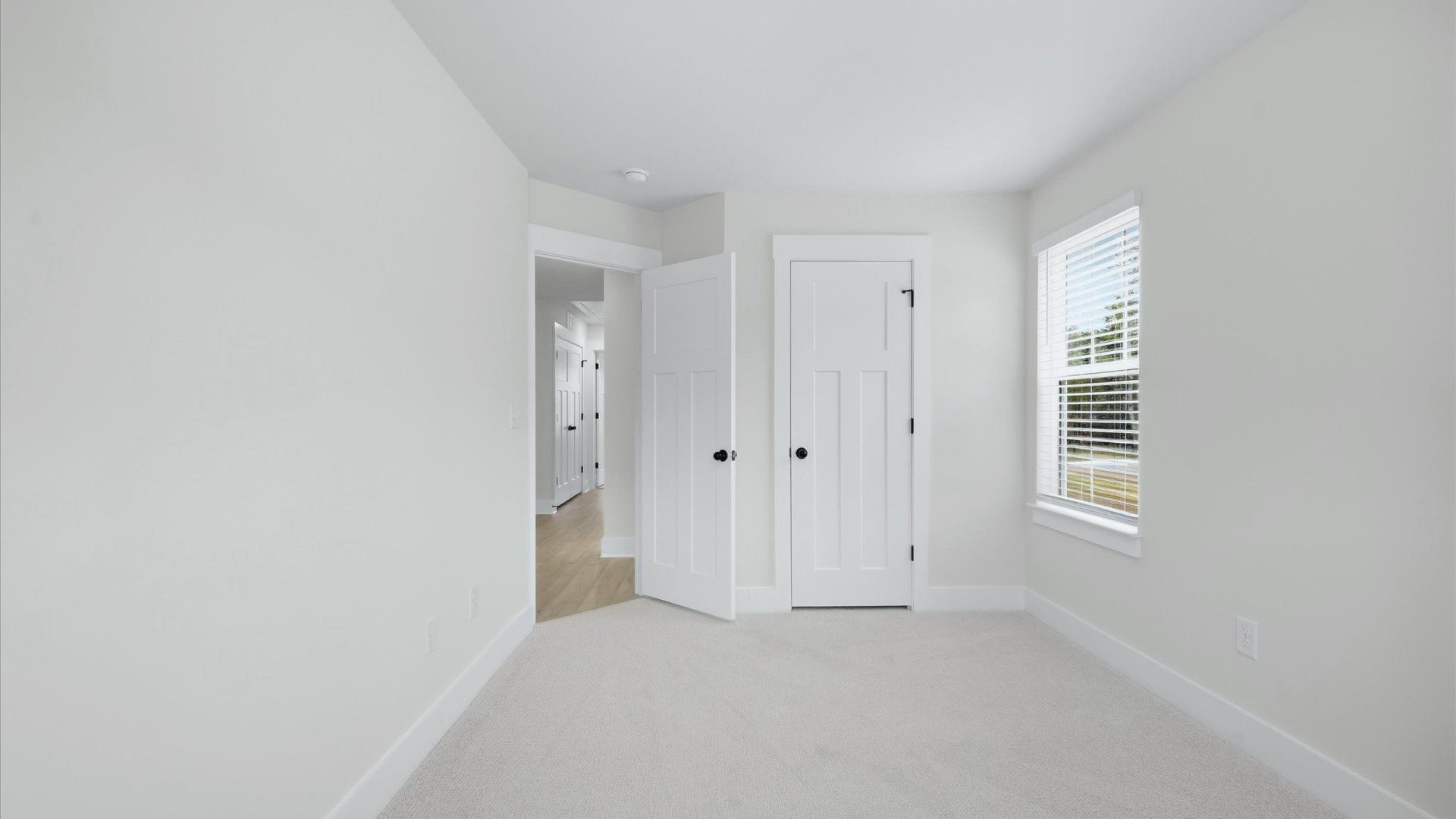 Superior comfort in a secondary bedroom with plush carpet and an oversized walk-in closet at Brookland Place
