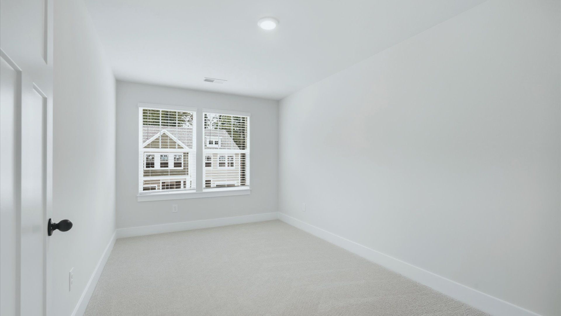 Refined bedroom design with large windows for daylight-filled mornings and peaceful views by DRB Homes