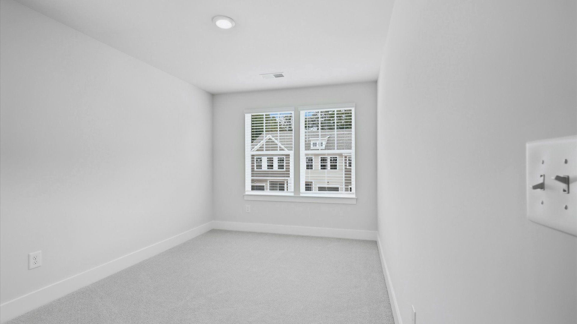 Highly functional bedroom with large windows, carpeted flooring, and tasteful finishes throughout in NC