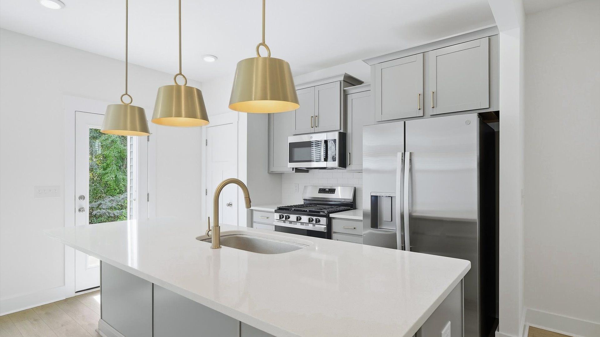 Tasteful design meets functional luxury in this kitchen with a 9-foot island and modern pendant lighting at El Dorado