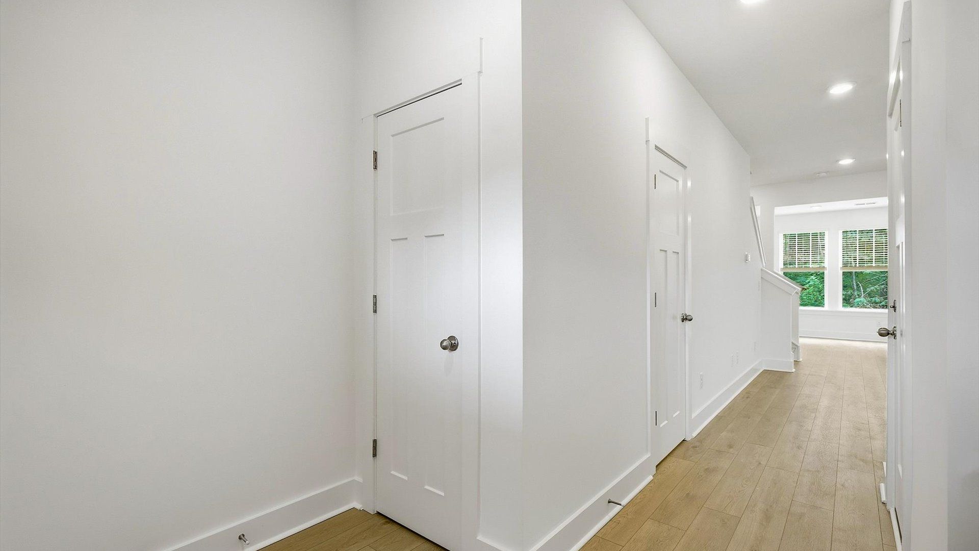 Notable hardwood flooring enhances the elegance of this accomplished entryway by DRB Homes