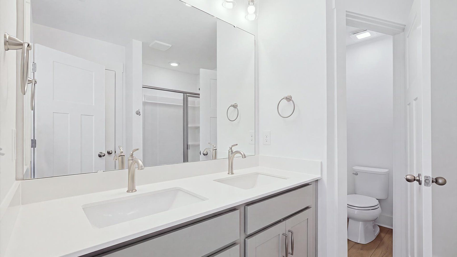 Notable primary bath featuring dual vanity, walk-in shower, and tasteful design touches throughout at El Dorado