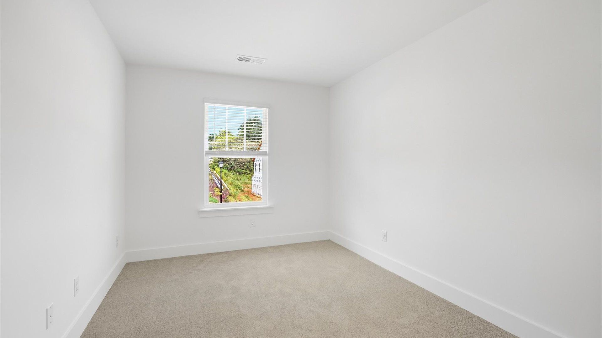 Superior comfort in this light-filled bedroom with plush carpeting and a thoughtfully placed large window at El Dorado