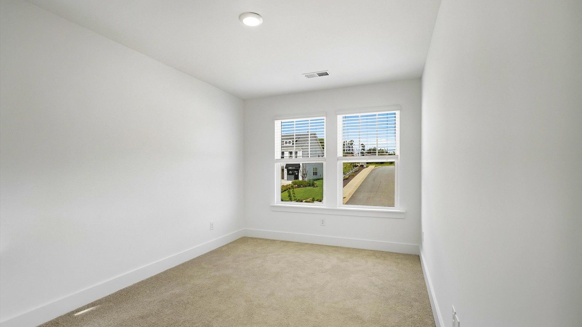 First-rate bedroom with plush carpeting and large windows that provide an open, airy feel at the El Dorado community