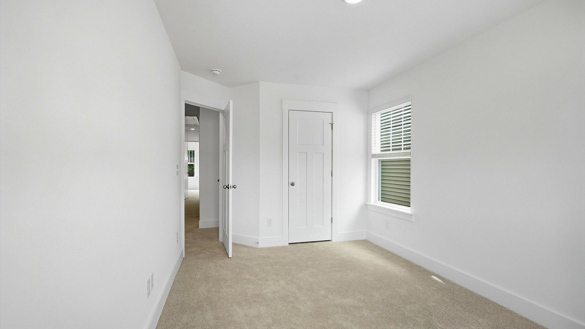 Elegant bedroom retreat featuring soft carpeting and a thoughtfully designed walk-in closet in Spartanburg, SC