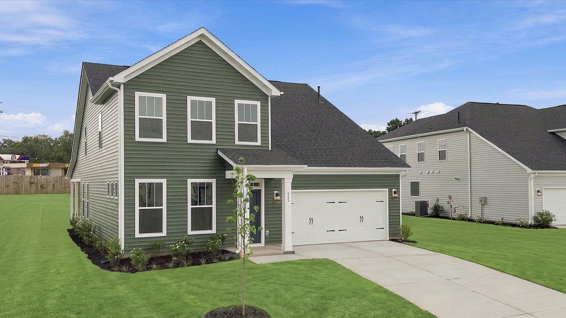 Exceptional home with tasteful exterior finishes and a thoughtfully designed façade at the Woodglen community