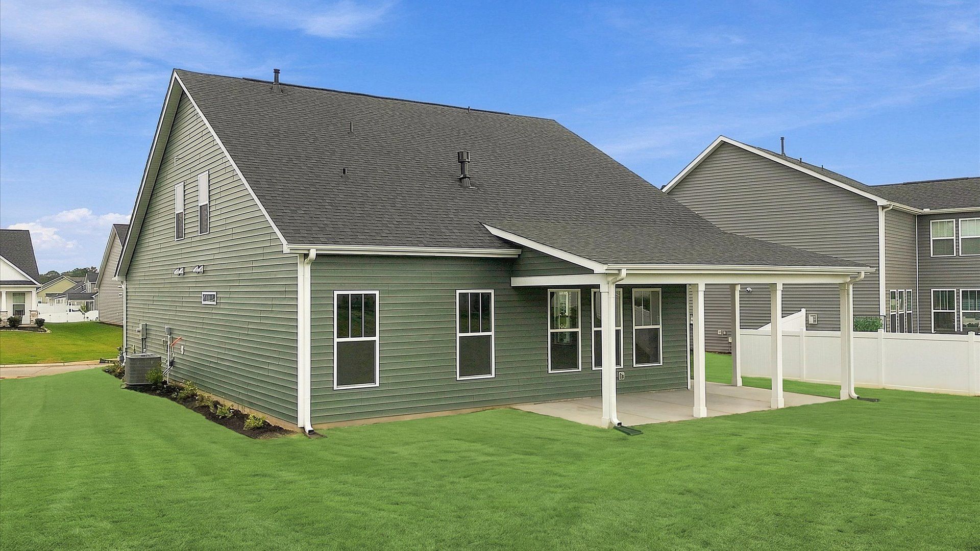 Vibrant rear outdoor space featuring a covered porch and exceptional craftsmanship