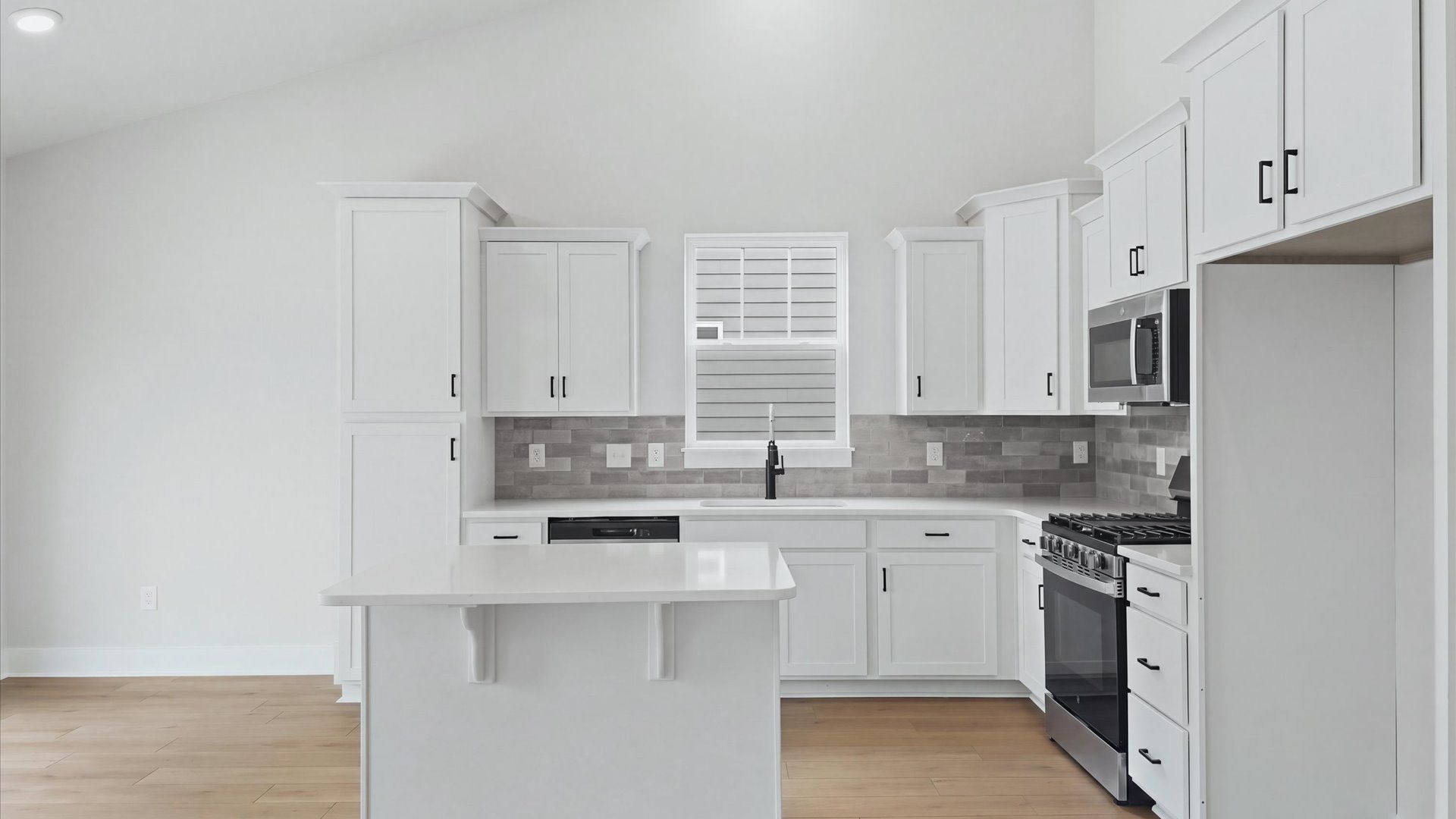 Tasteful kitchen with a streamlined island and modern finishes in a first-class DRB Homes design