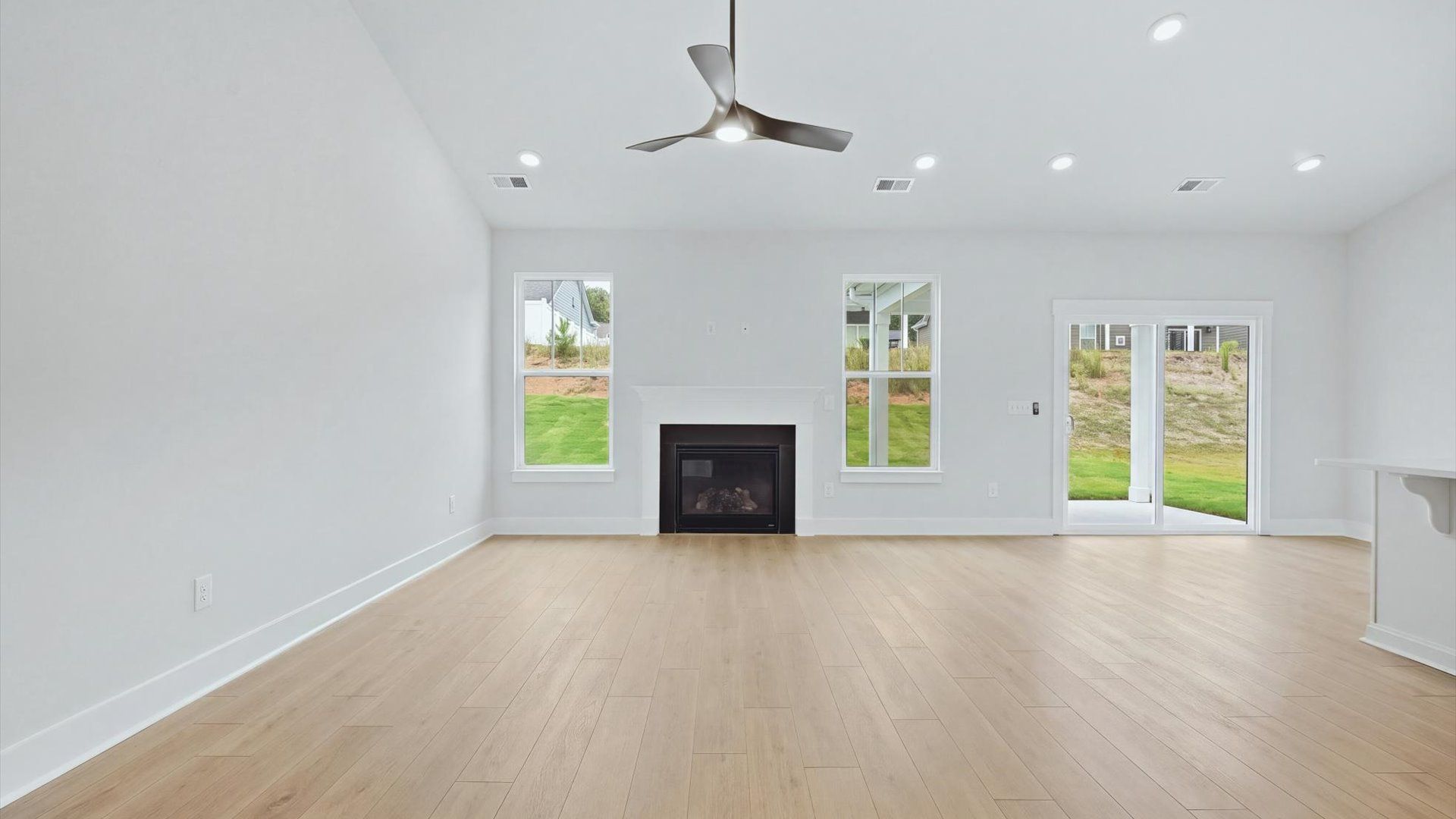 First-rate family room with thoughtful layout and superior connection to kitchen and dining spaces at Creeks at Midway