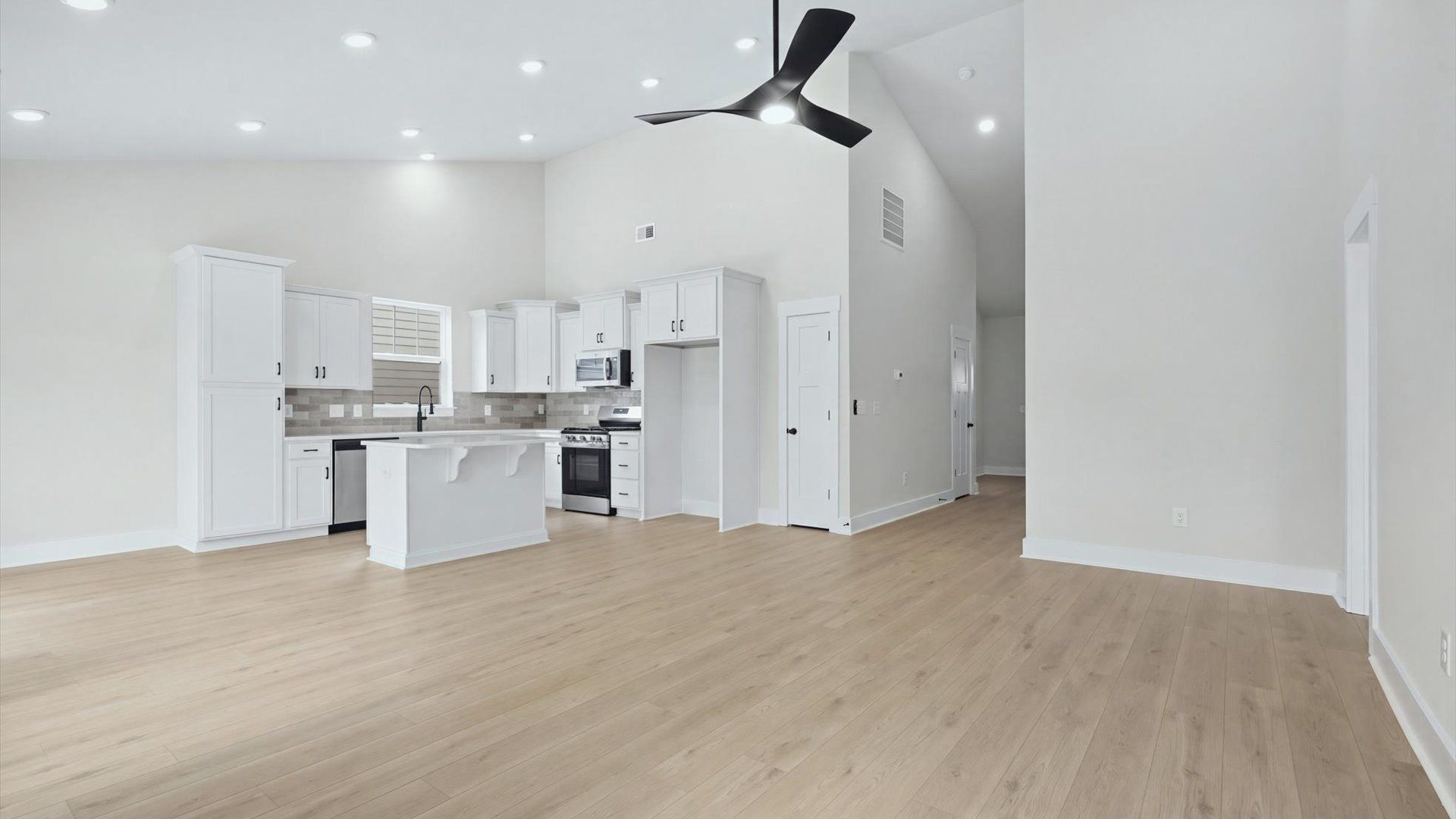 Vibrant family room with high-impact two-story ceilings and thoughtful layout for entertaining by DRB Homes