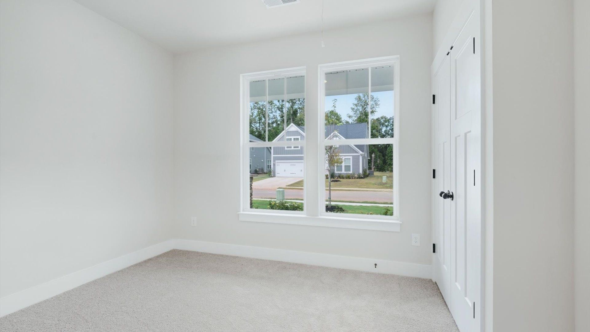 Vibrant and restful bedroom with oversized windows, refined detail, and a warm, welcoming atmosphere
