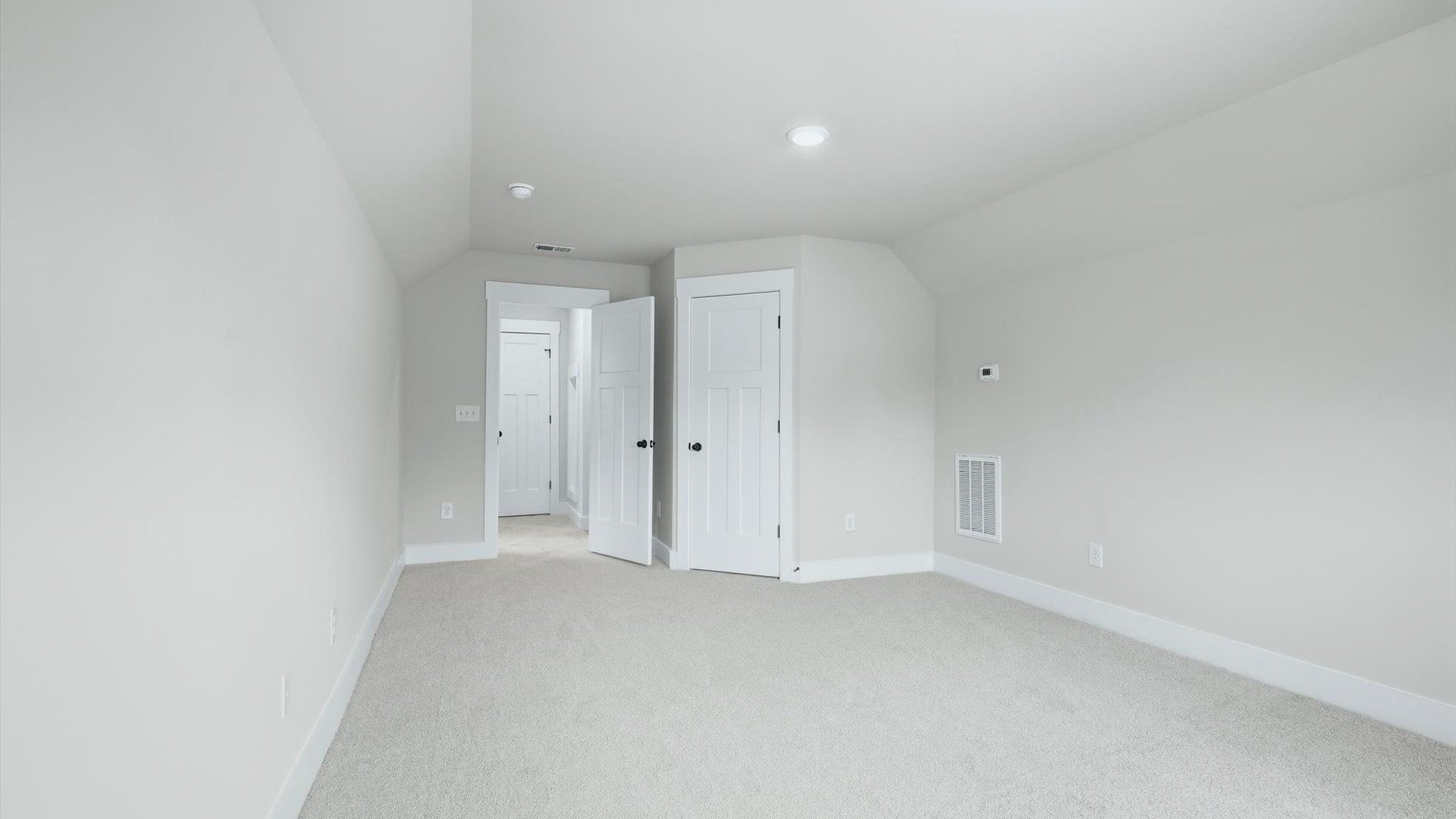 Tasteful bedroom with plush carpet, a walk-in closet, and large windows for abundant natural light in Anderson, SC