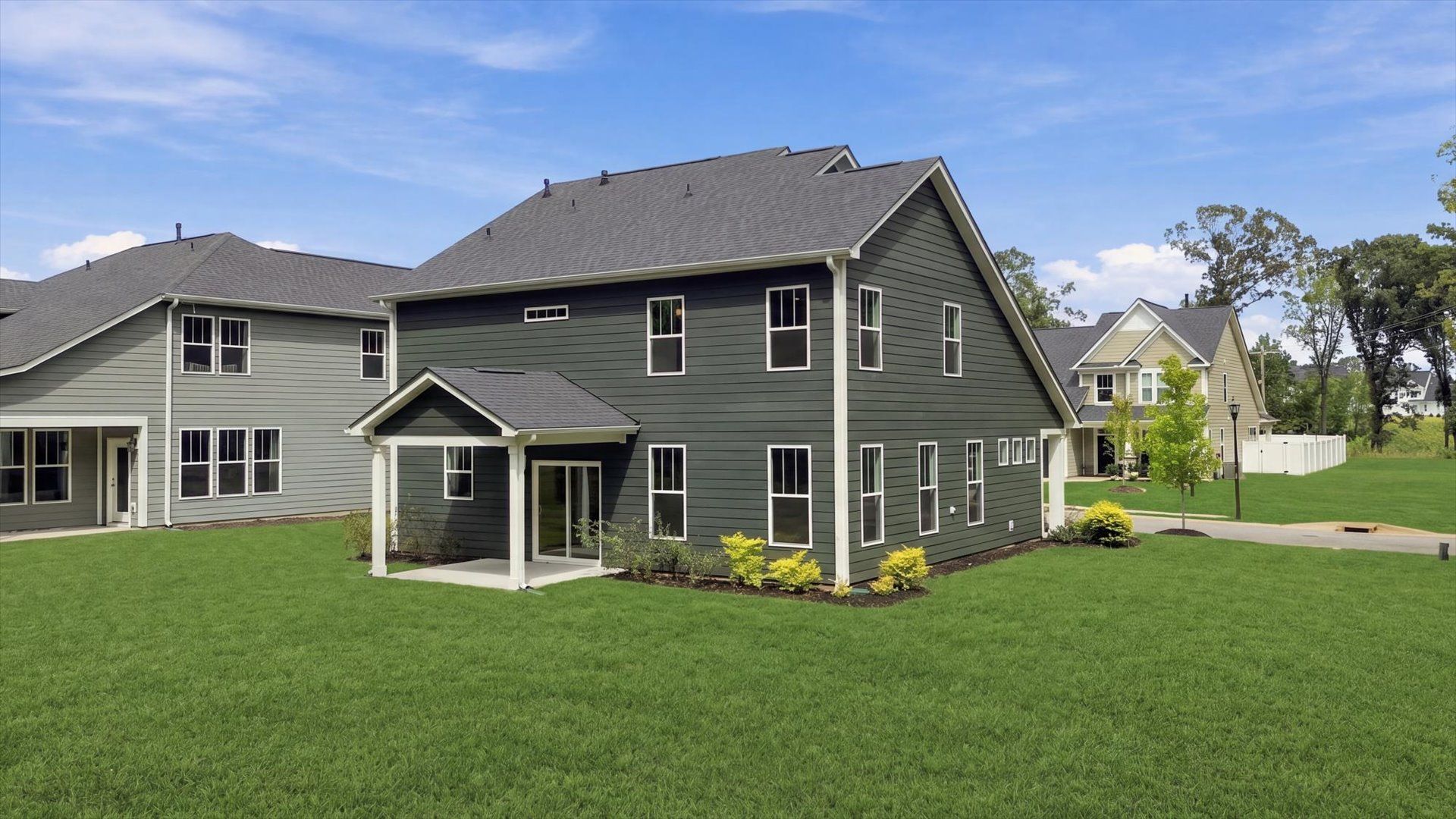 Notable exterior includes a rear covered porch designed for year-round enjoyment at Creeks at Midway