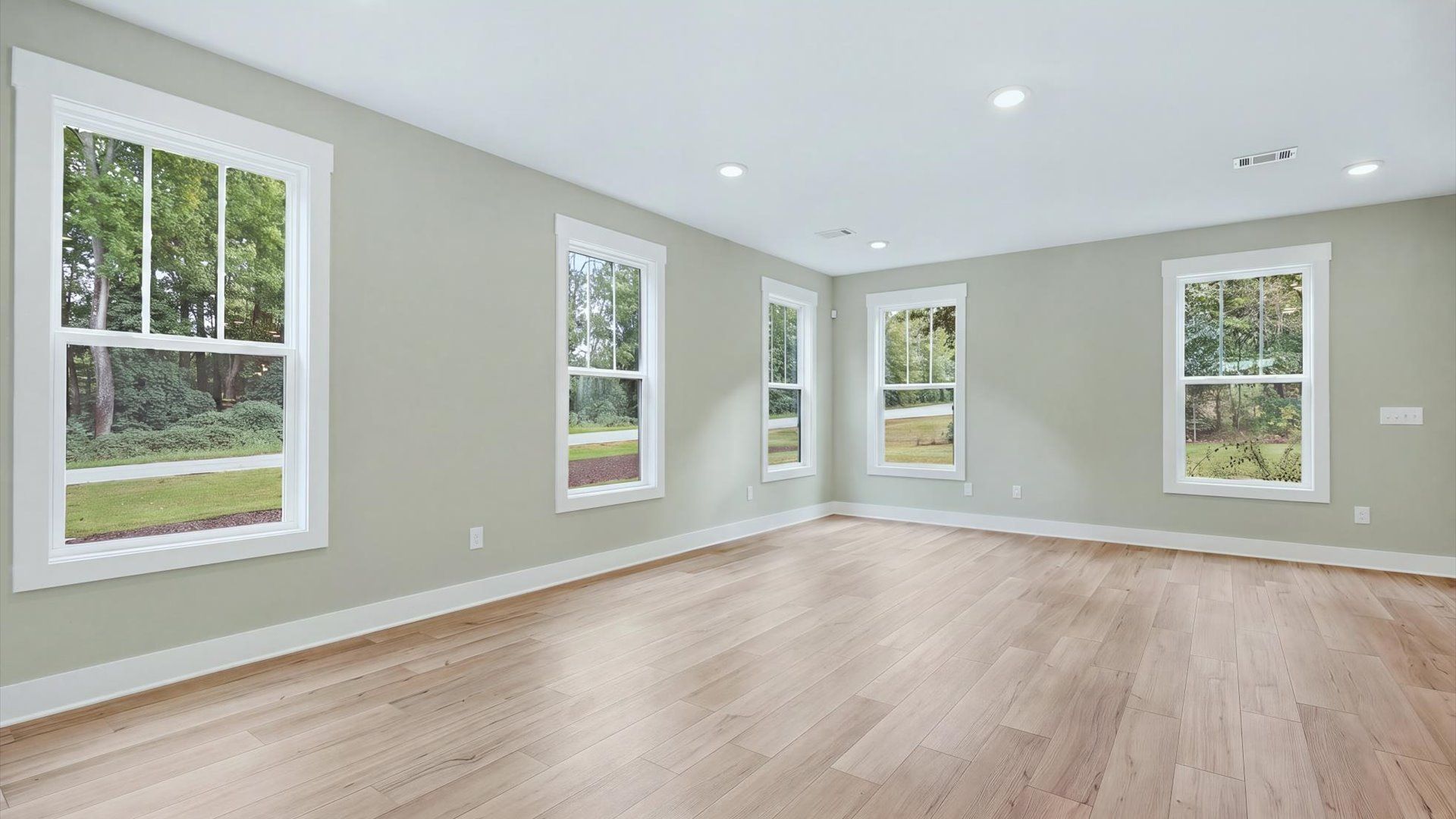 Memorable moments begin in this elegant, open family room with hardwood flooring and refined finishes near Lake Hartwell