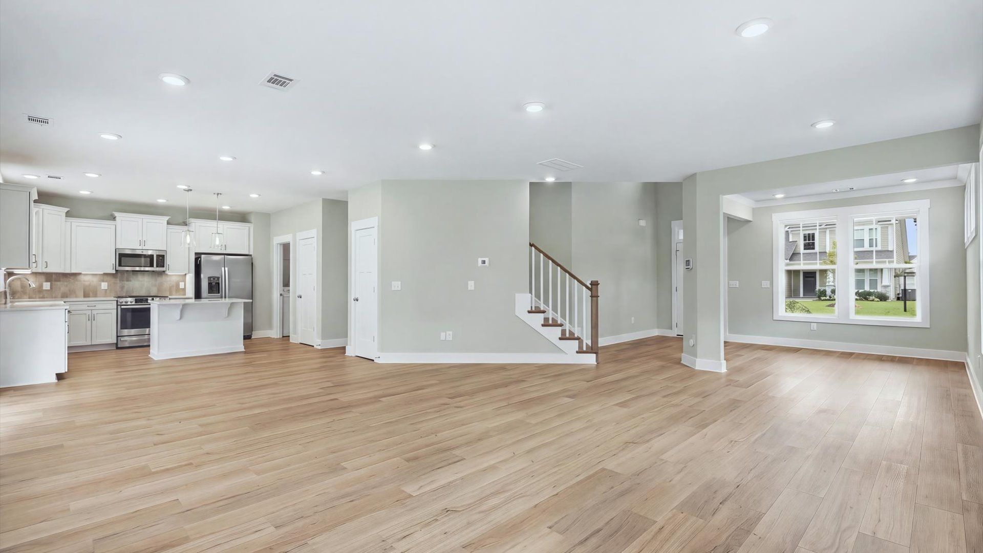 Hardwood flooring and high standards define this vibrant family room ideal for everyday living at Creeks at Midway