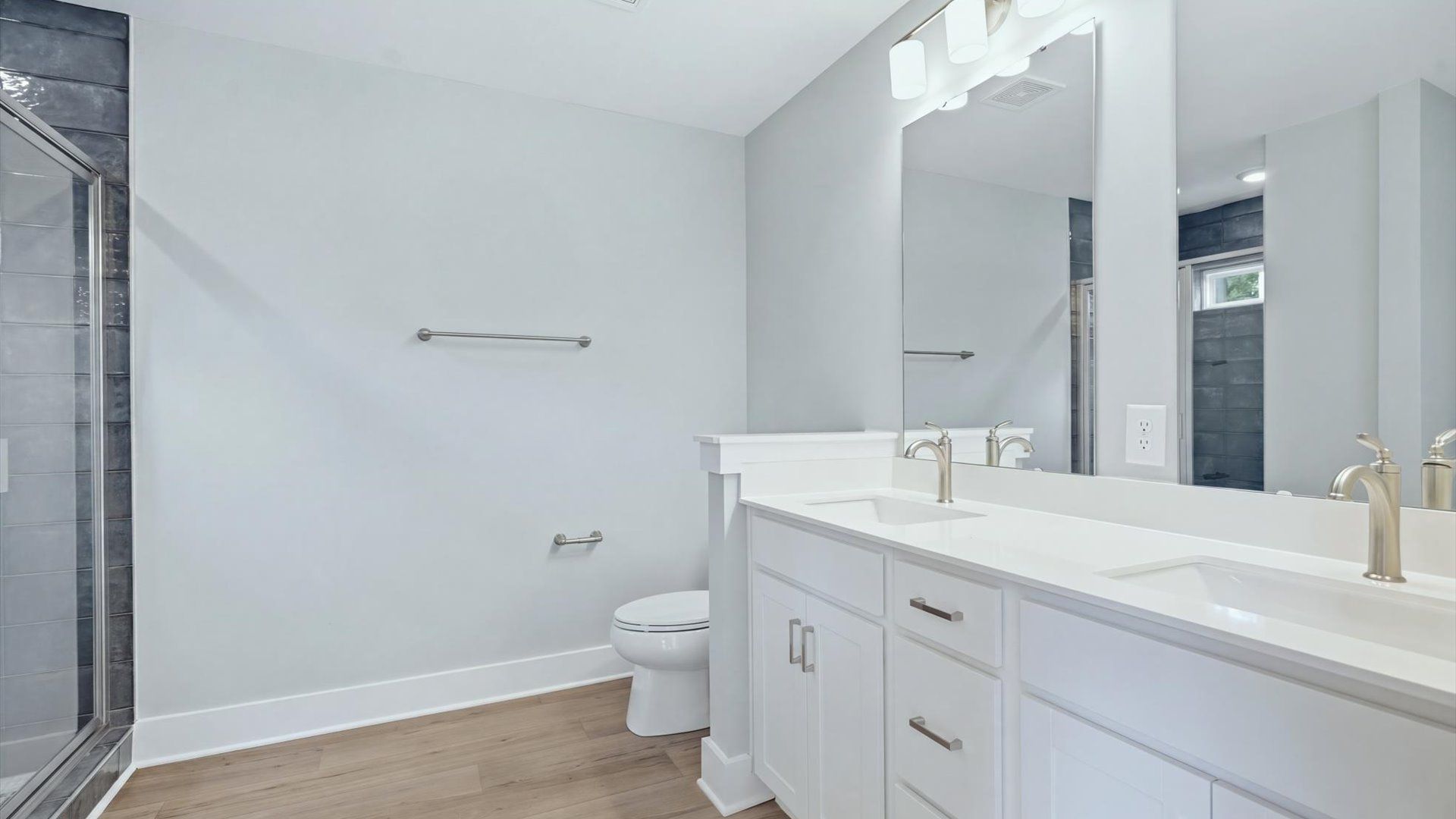 Highly functional and elegant en-suite with dual vanities, tiled walk-in shower, and refined finishes at Creeks at Midway
